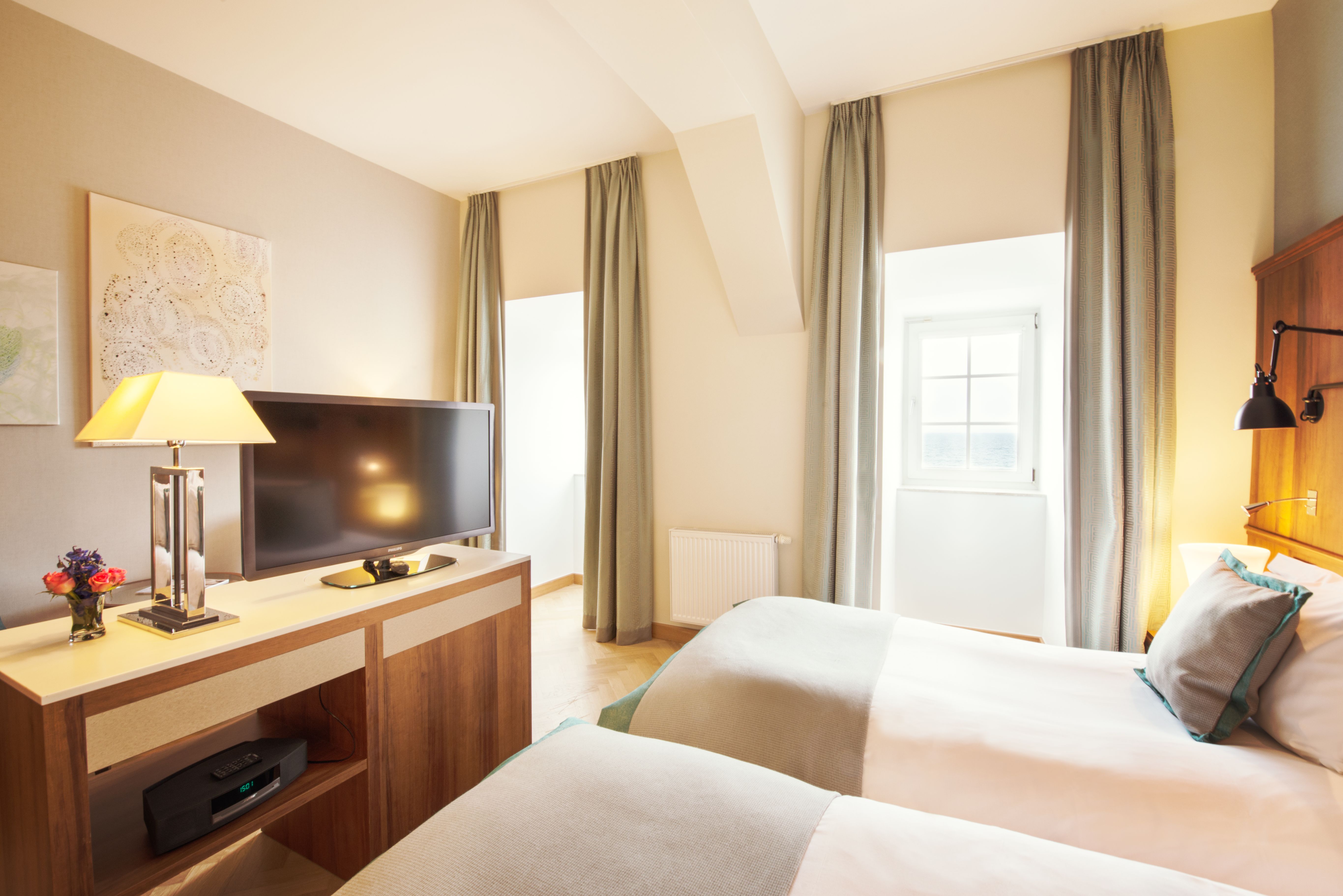 a room with two beds and a tv