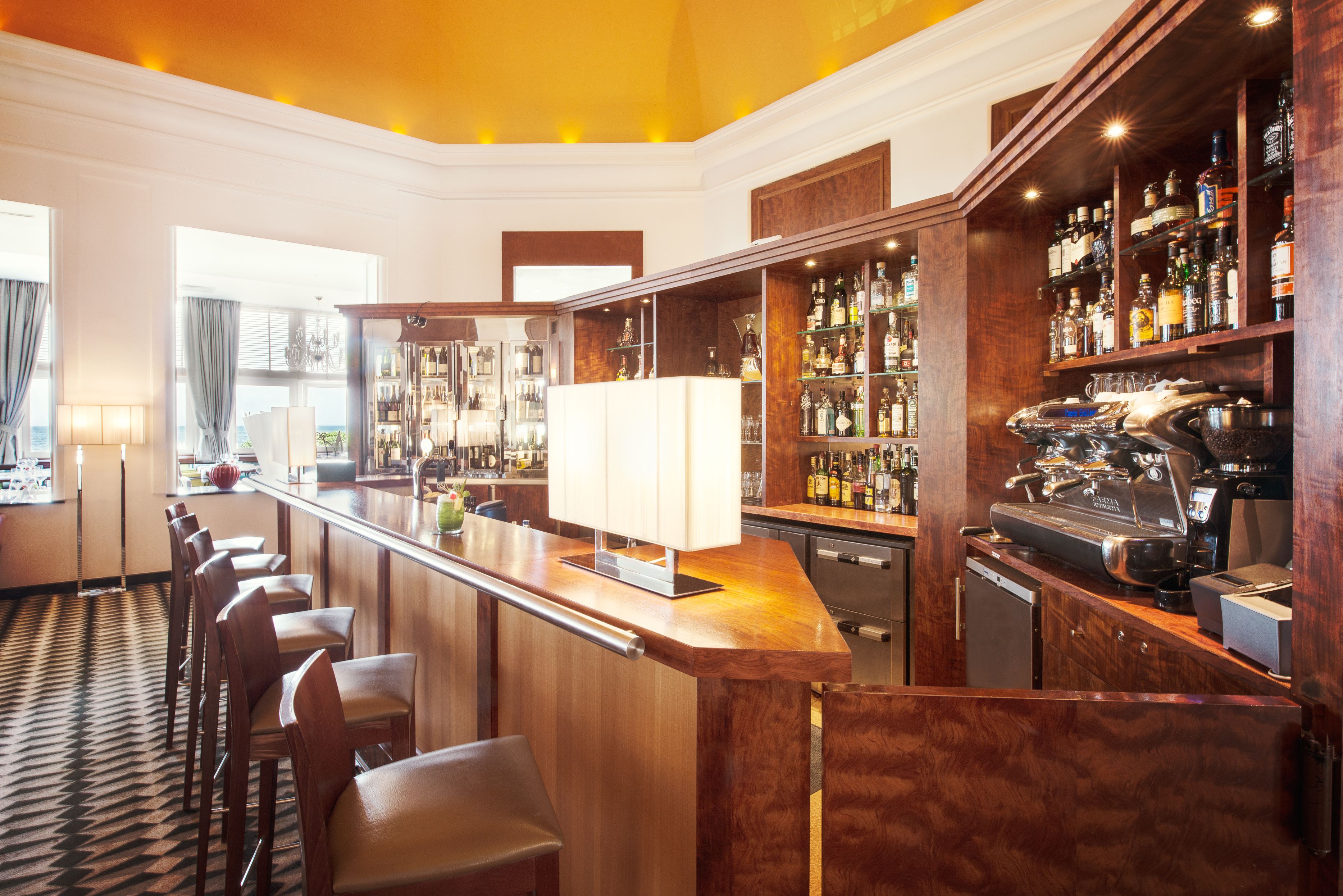 a bar with shelves and chairs