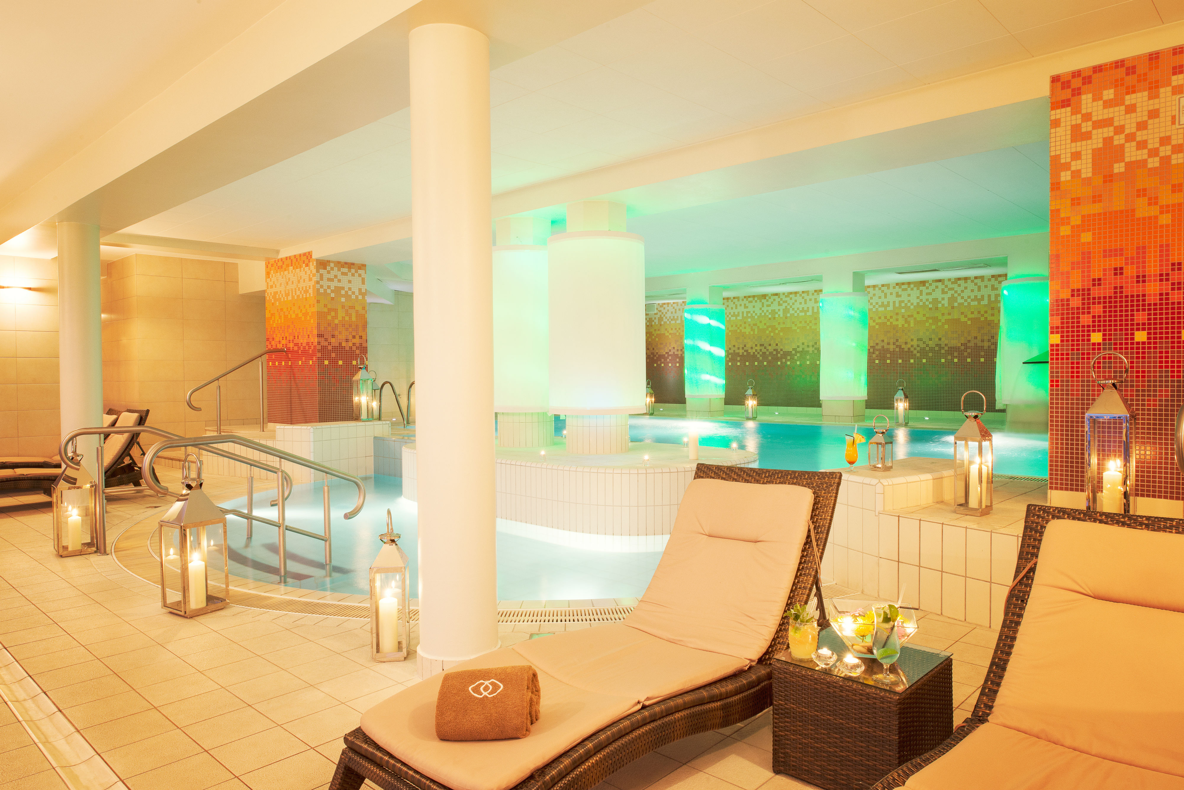 a pool with a lounge chair and a table