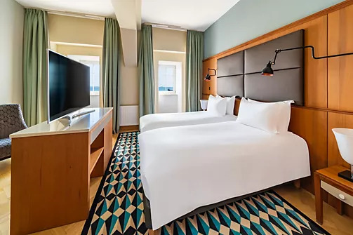 a room with two beds and a tv