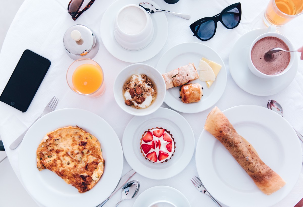 a table with plates of food and glasses