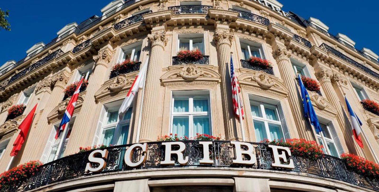 a building with a balcony and flags