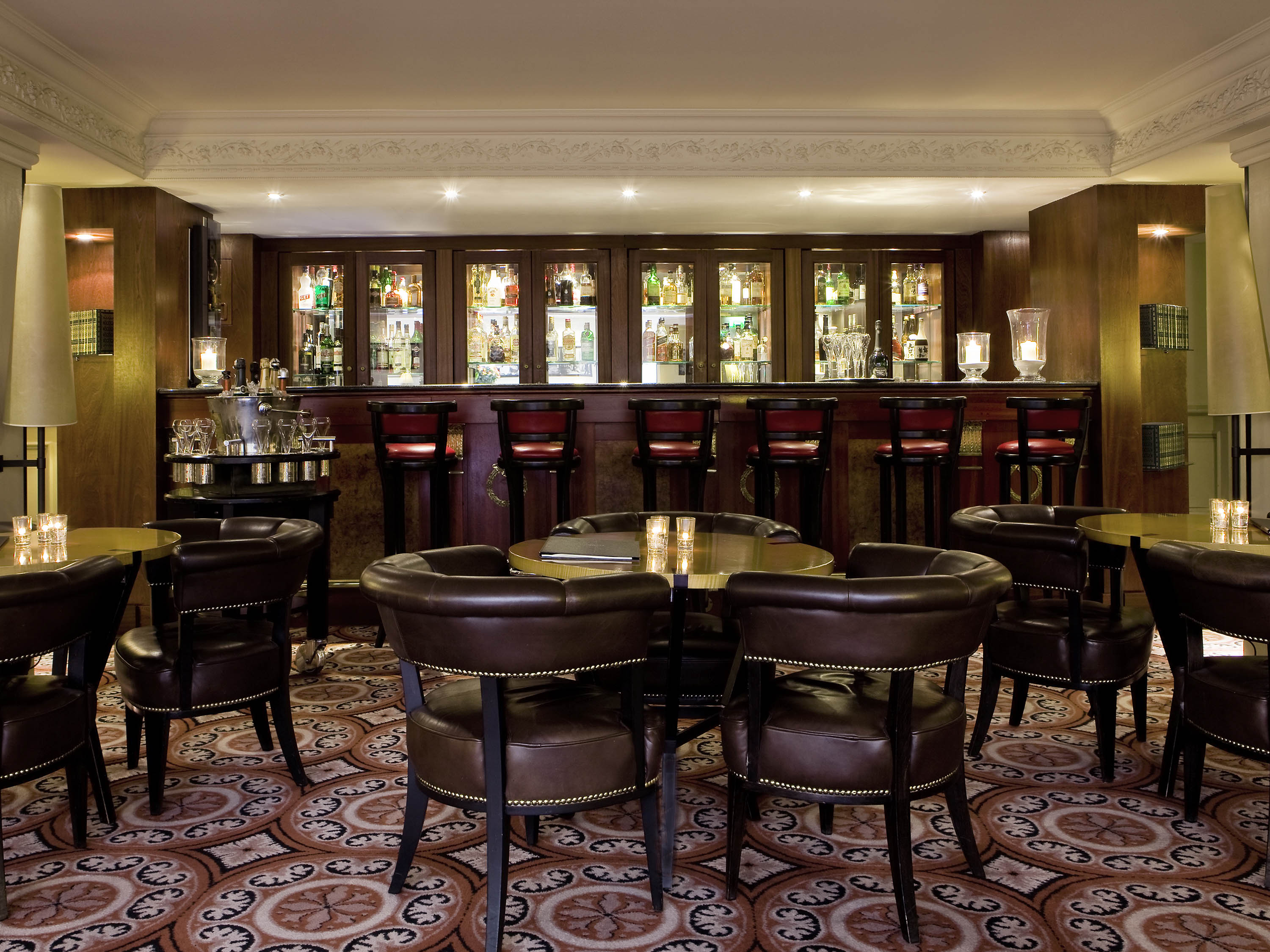 a room with a bar and chairs
