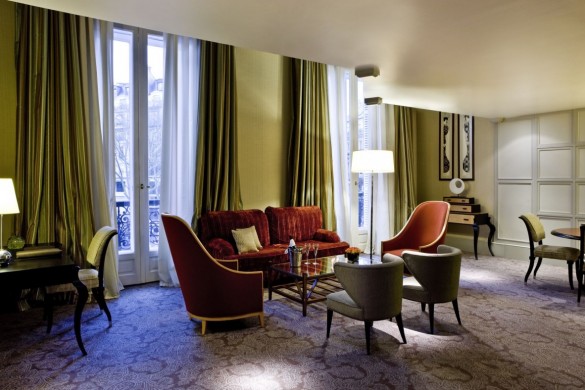 a room with a couch and chairs