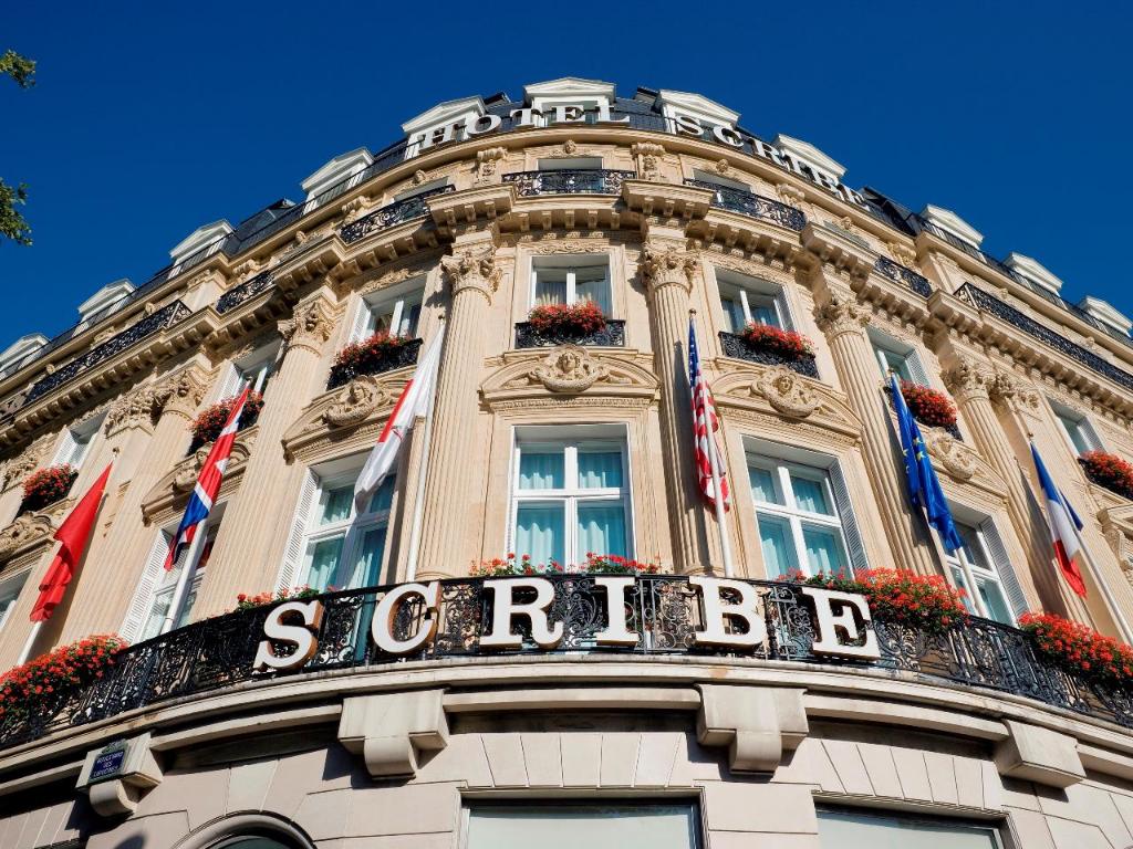 a building with a balcony and flags