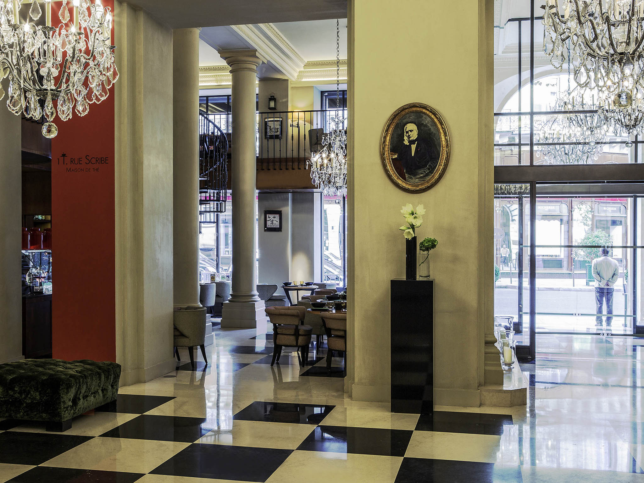 a room with a checkered floor and a chandelier