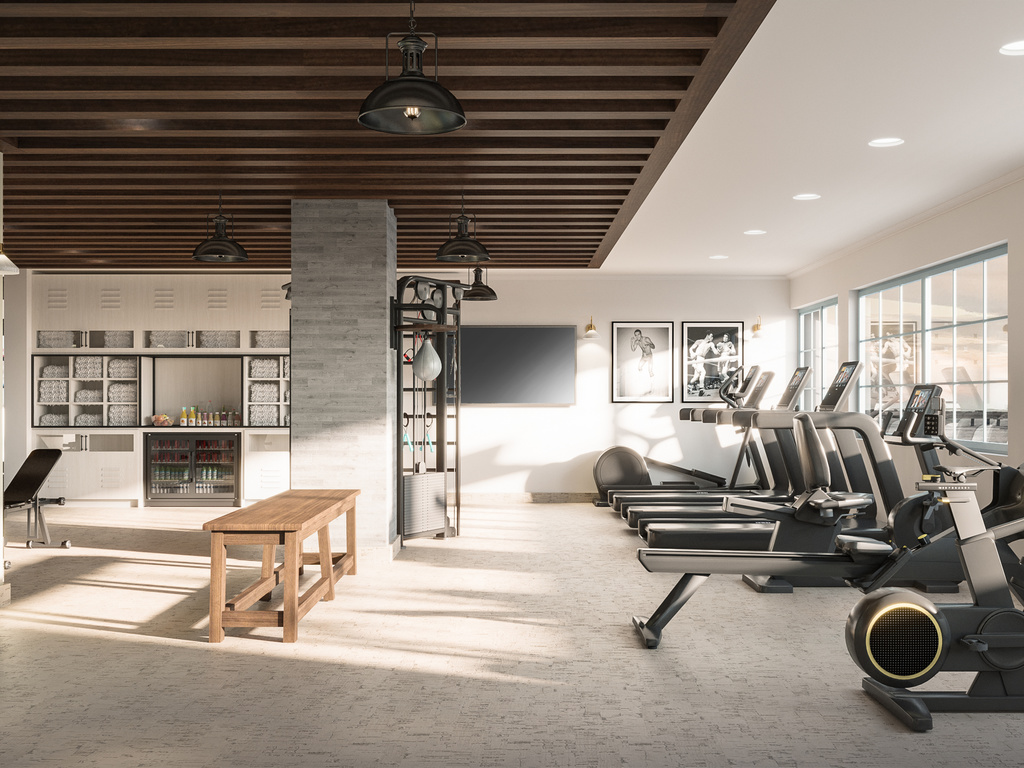 a gym with treadmills and a bench
