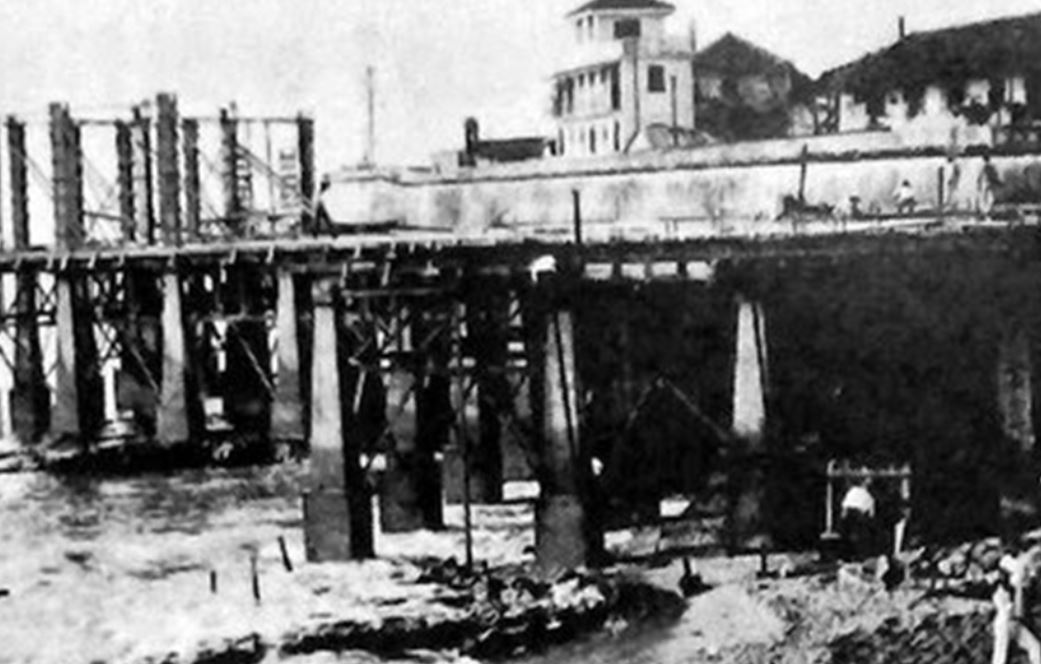 a bridge with a building in the background