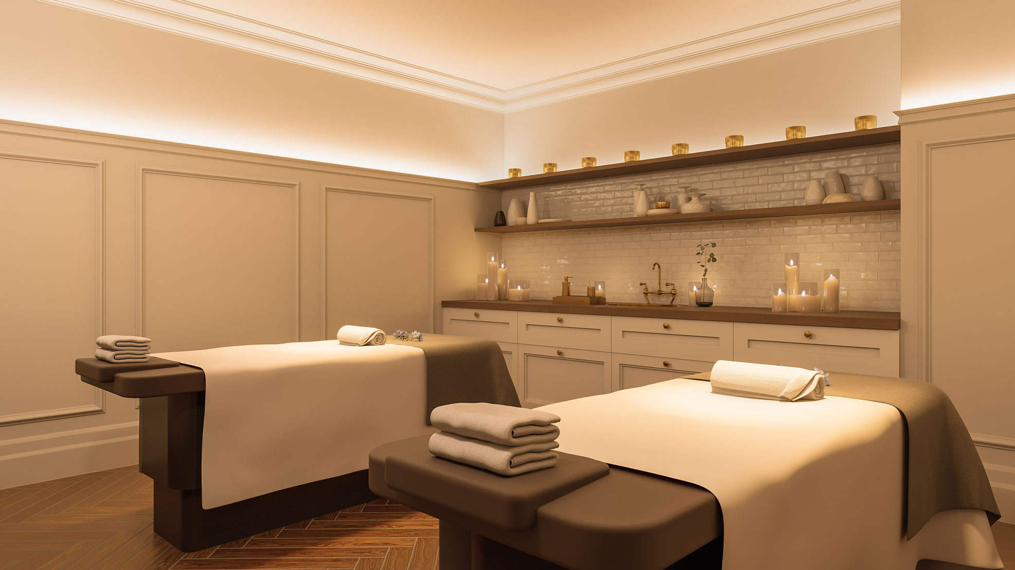 a massage room with white beds and candles