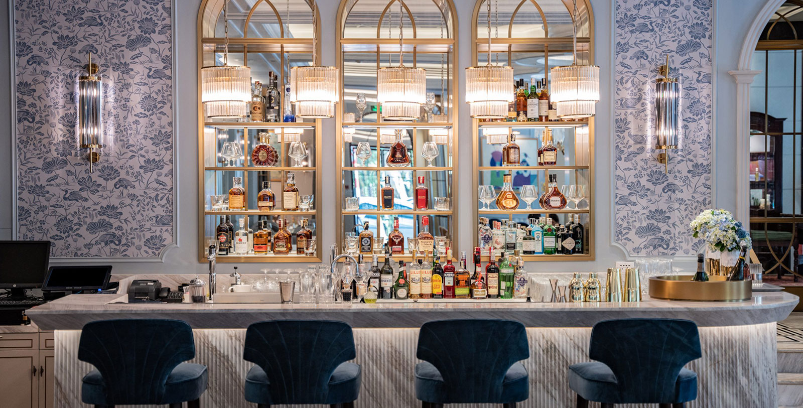 a bar with bottles of alcohol and chairs
