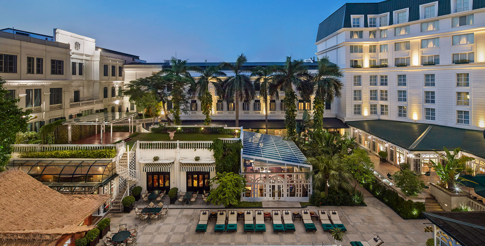 a hotel with palm trees and a pool