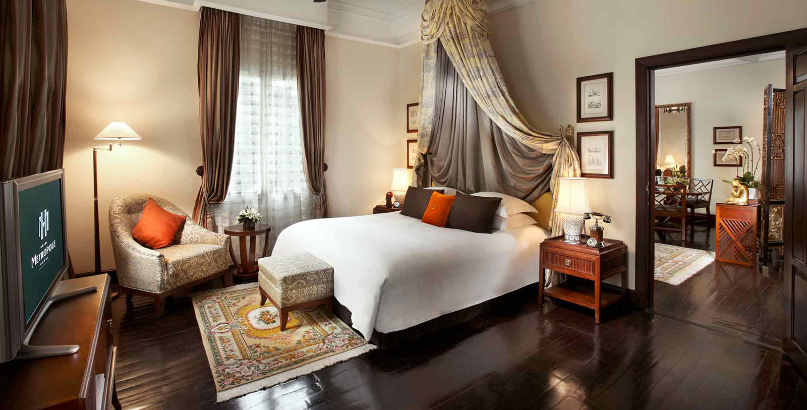 a bedroom with a canopy bed and a chair
