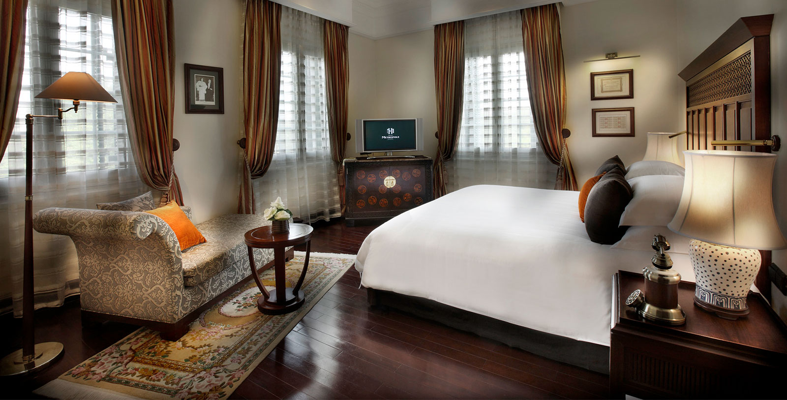 a bedroom with a bed and a television