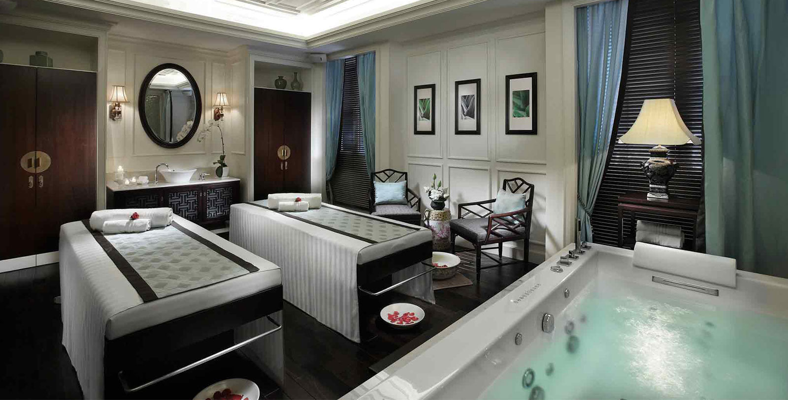 a room with two beds and a hot tub