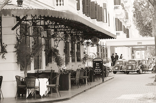 a restaurant with tables and chairs on the side of the street