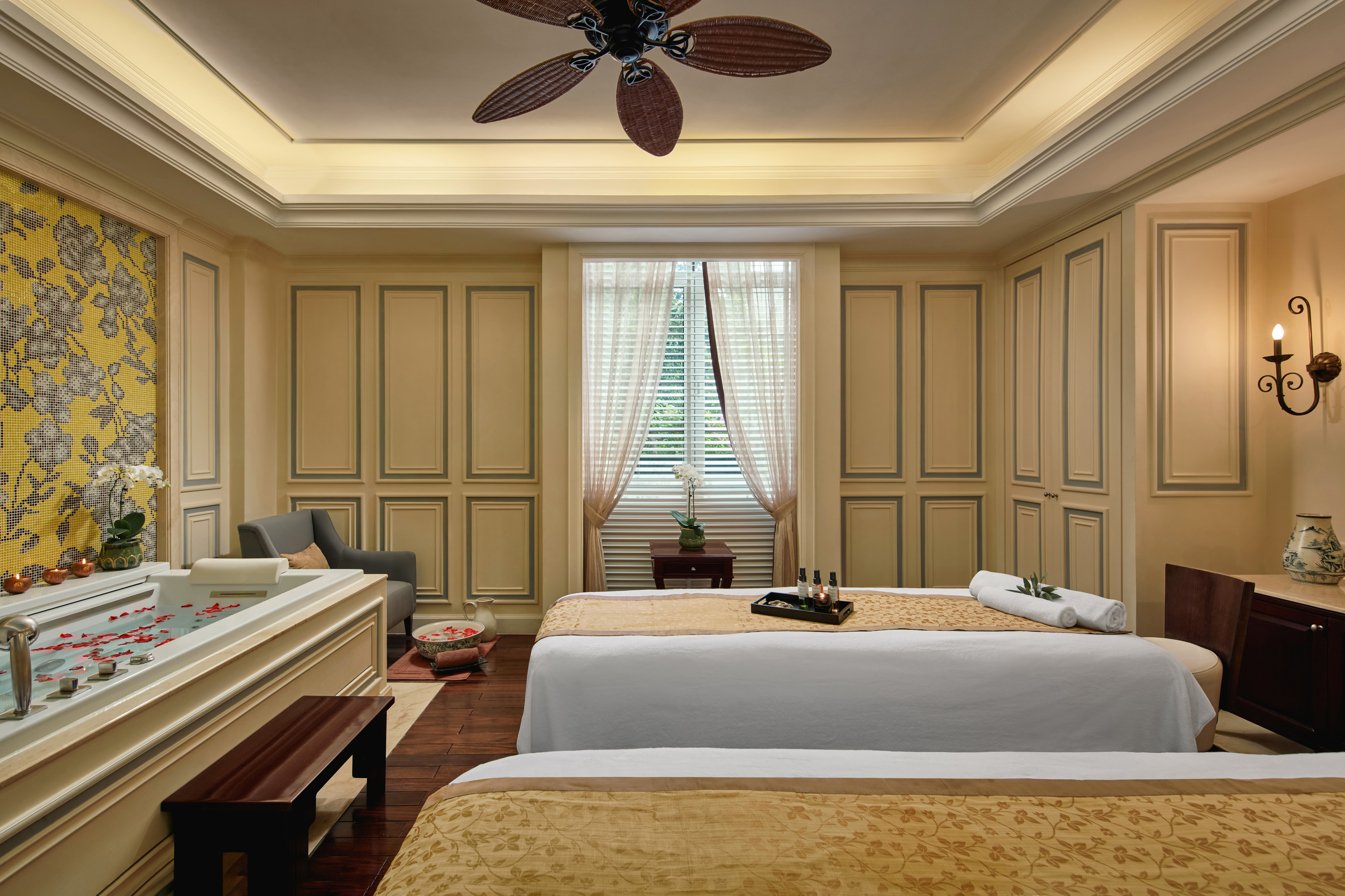 a room with two beds and a fan