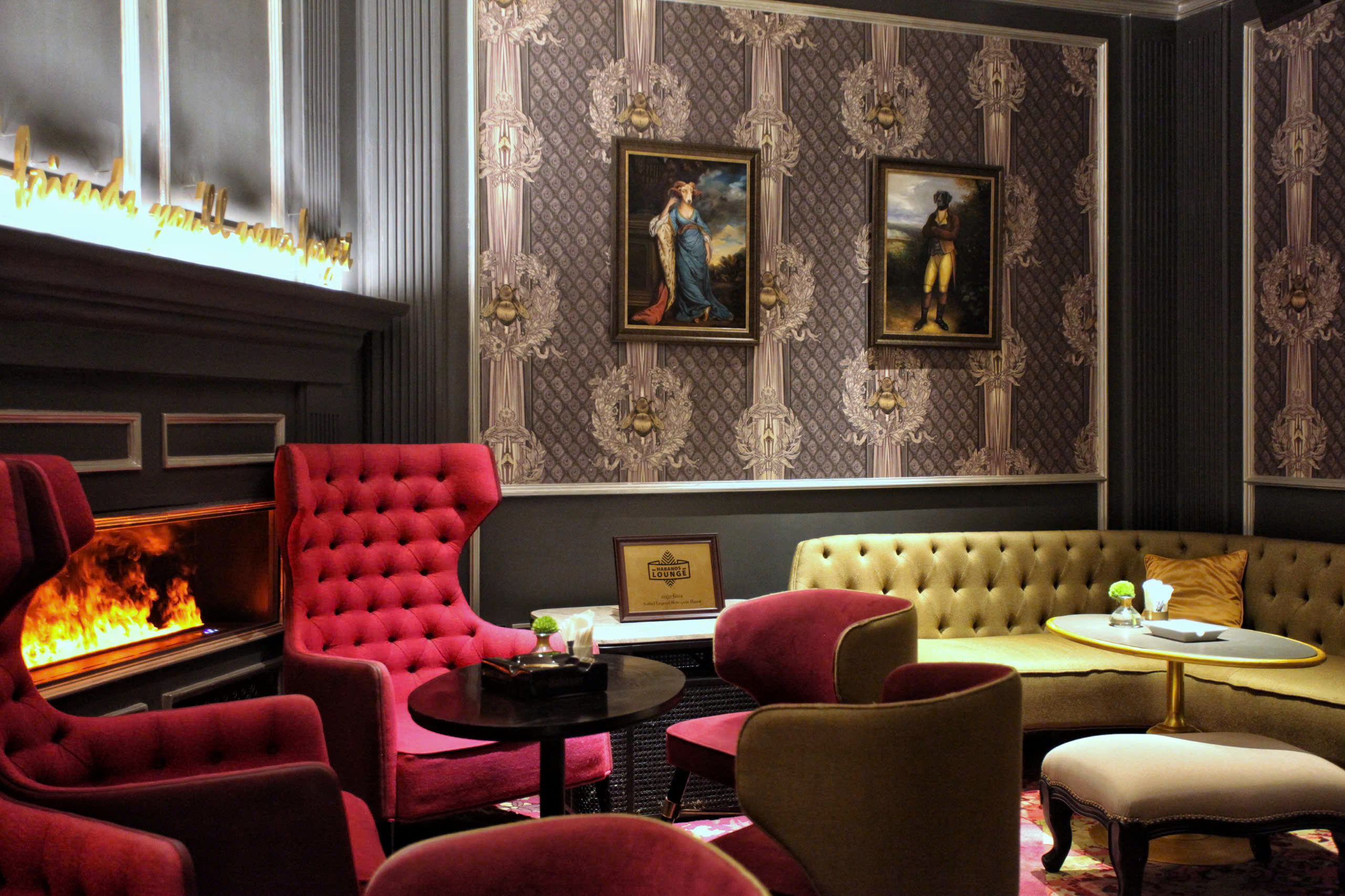 a room with a fireplace and chairs