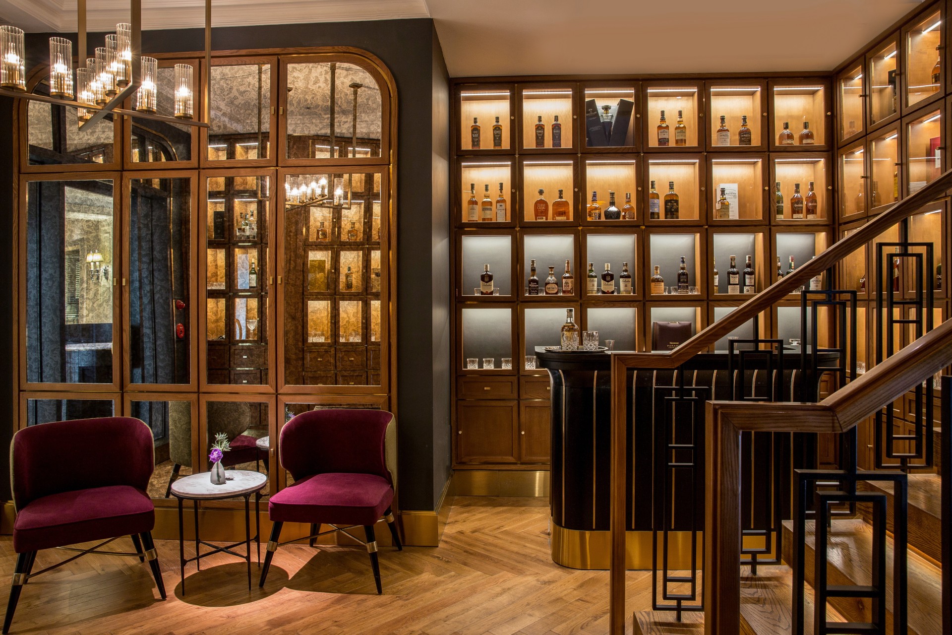 a room with a bar and shelves of liquor