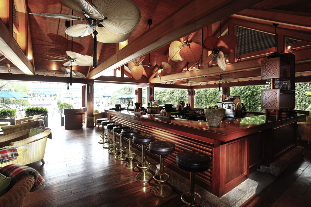 a bar with stools and fan
