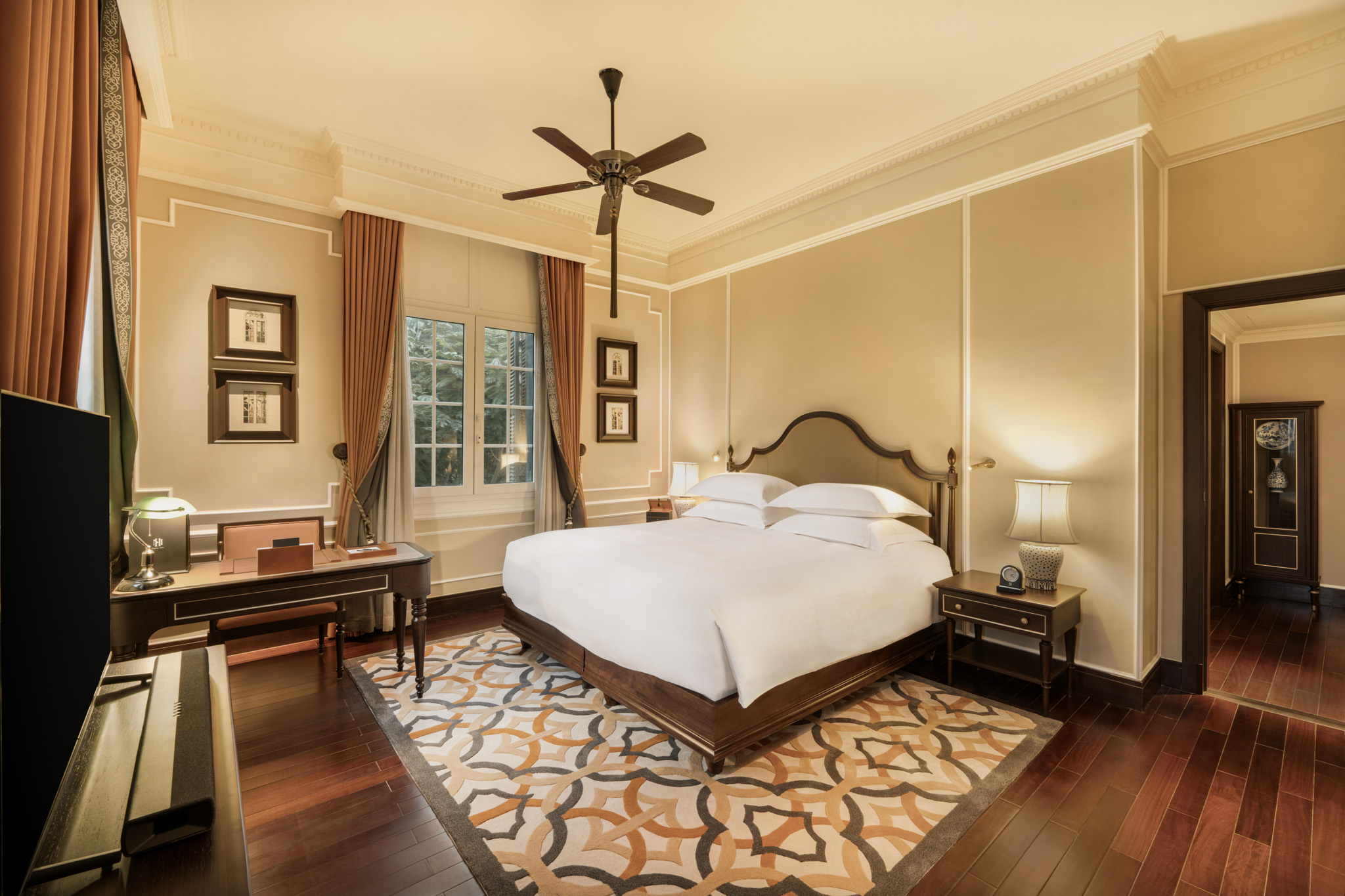 a bedroom with a bed and a ceiling fan