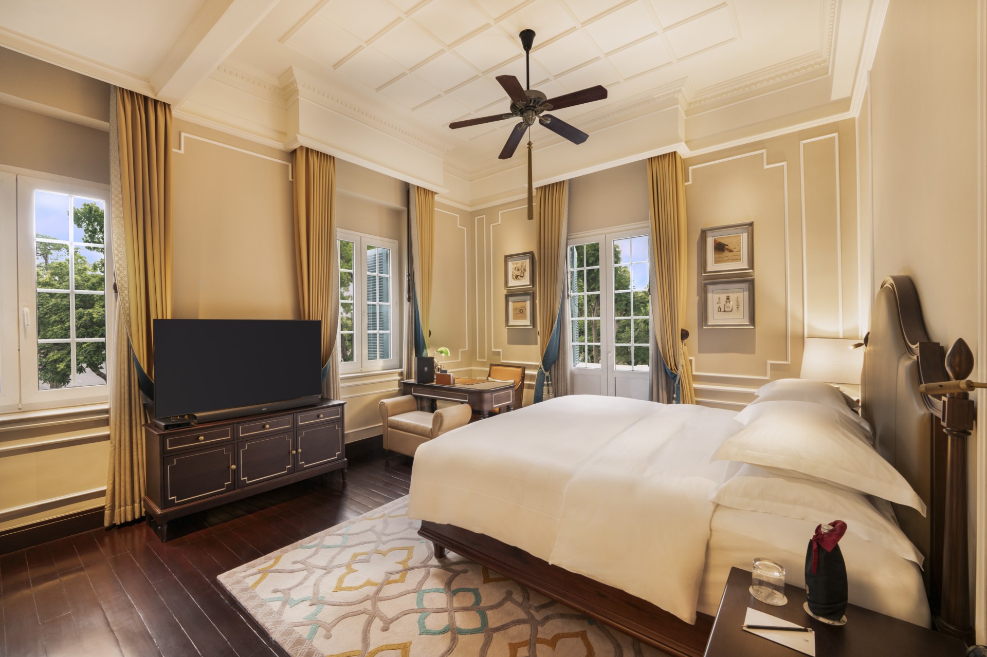 a room with a bed and a television