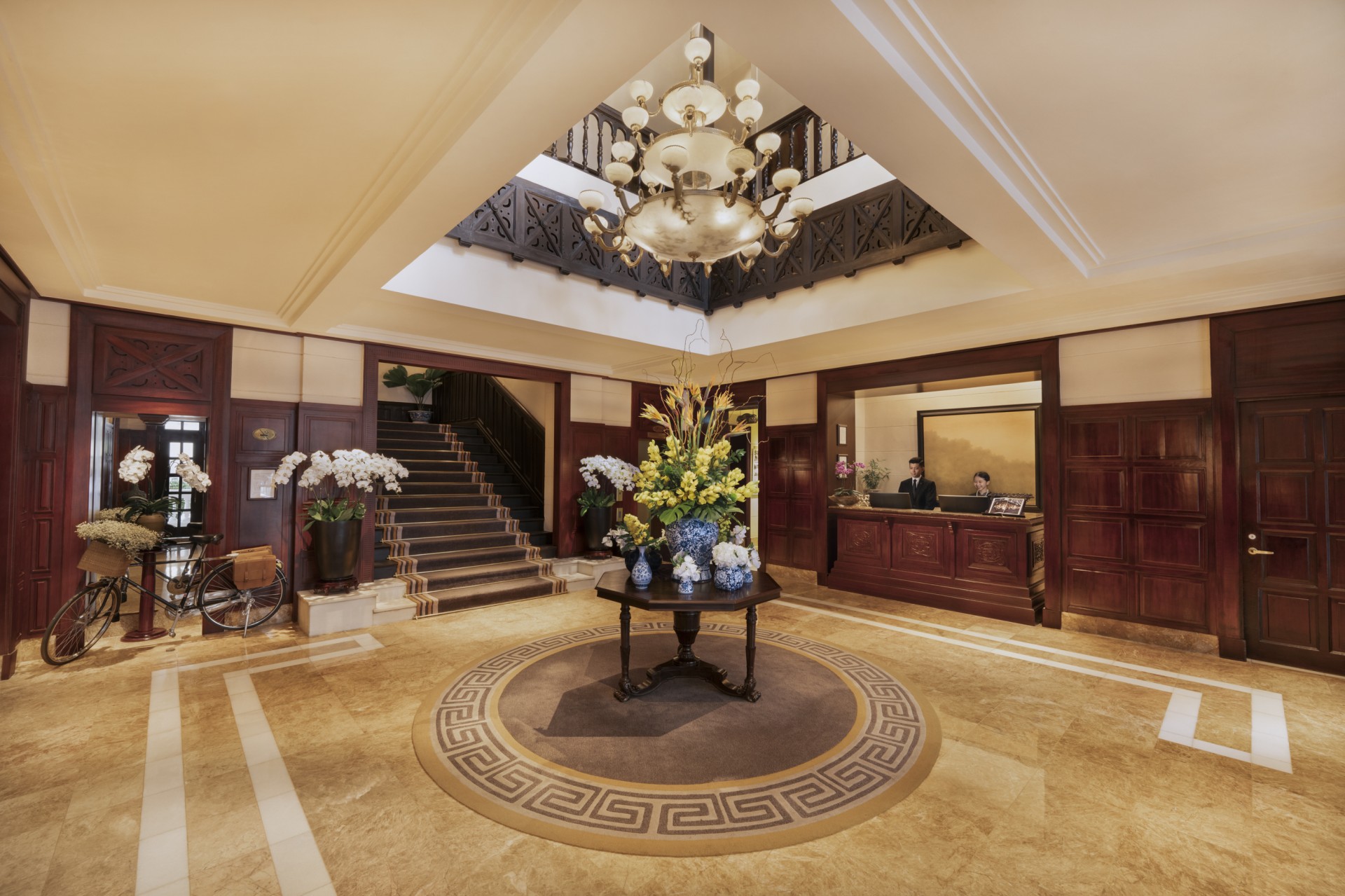 a lobby with a table and flowers