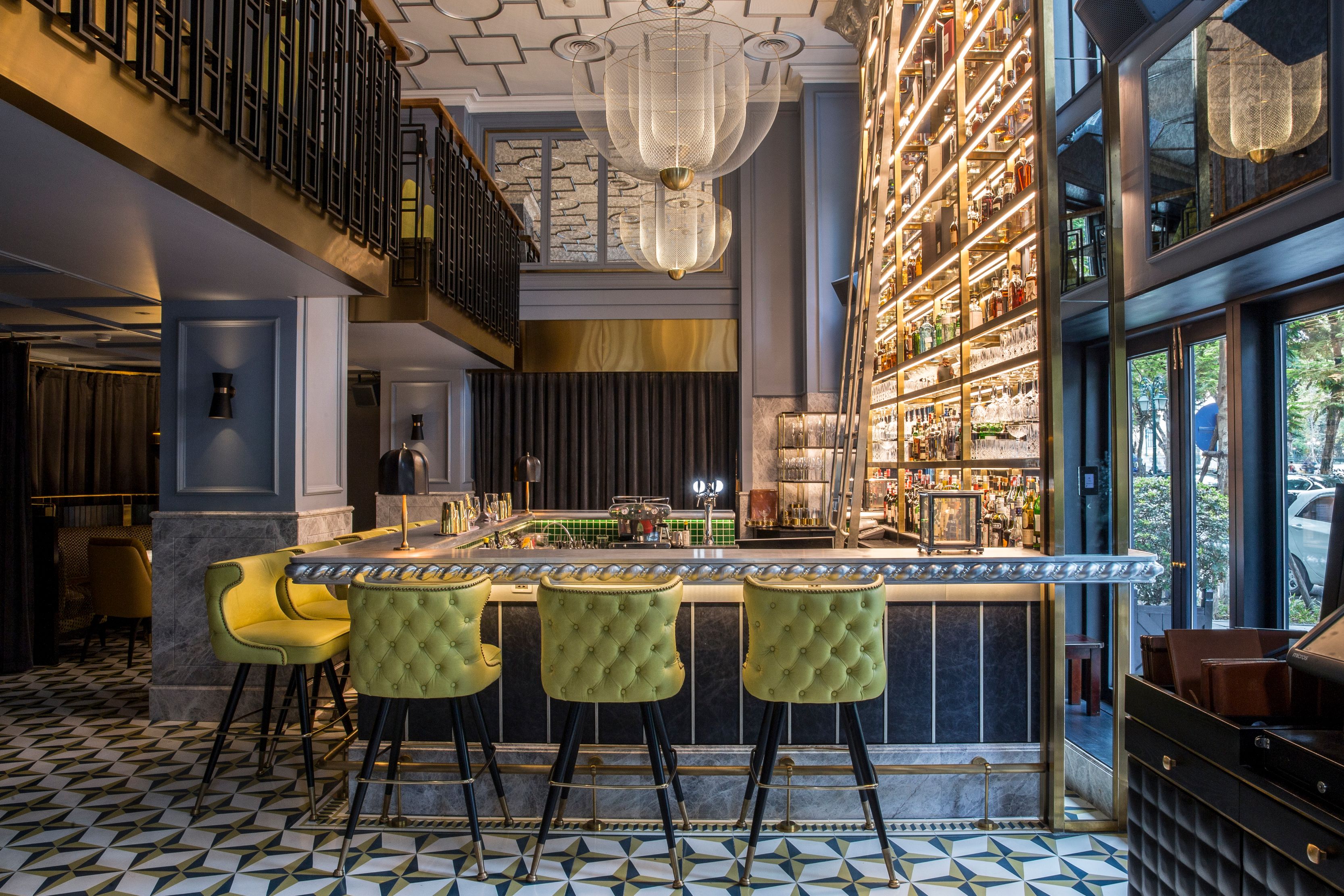 a bar with a bar stools and a shelf with lights