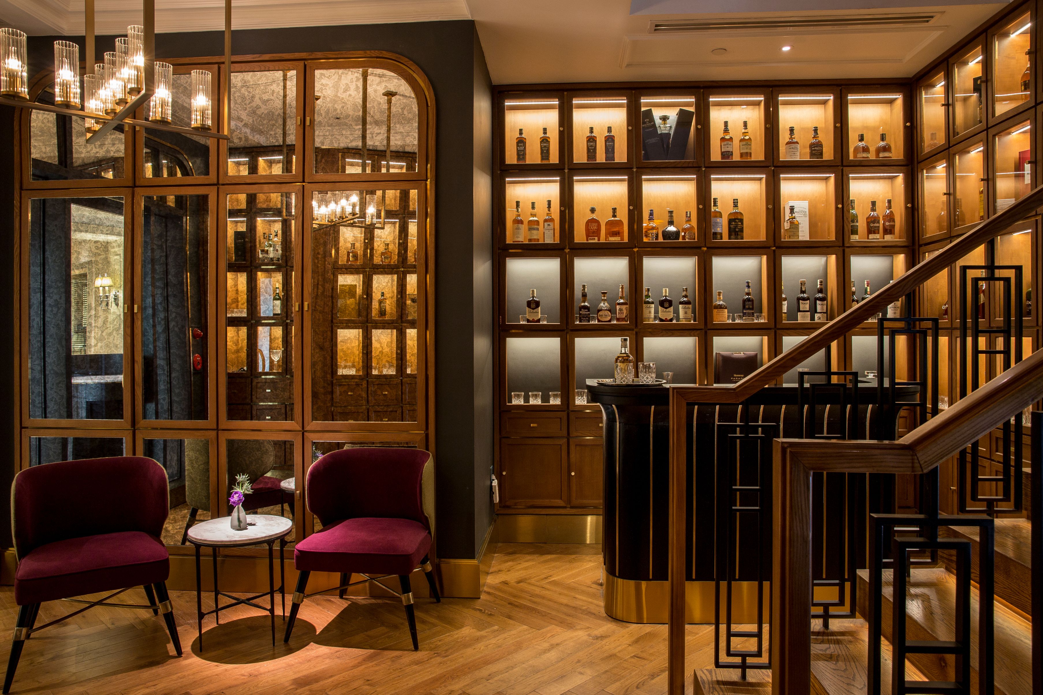 a room with a bar and shelves of liquor