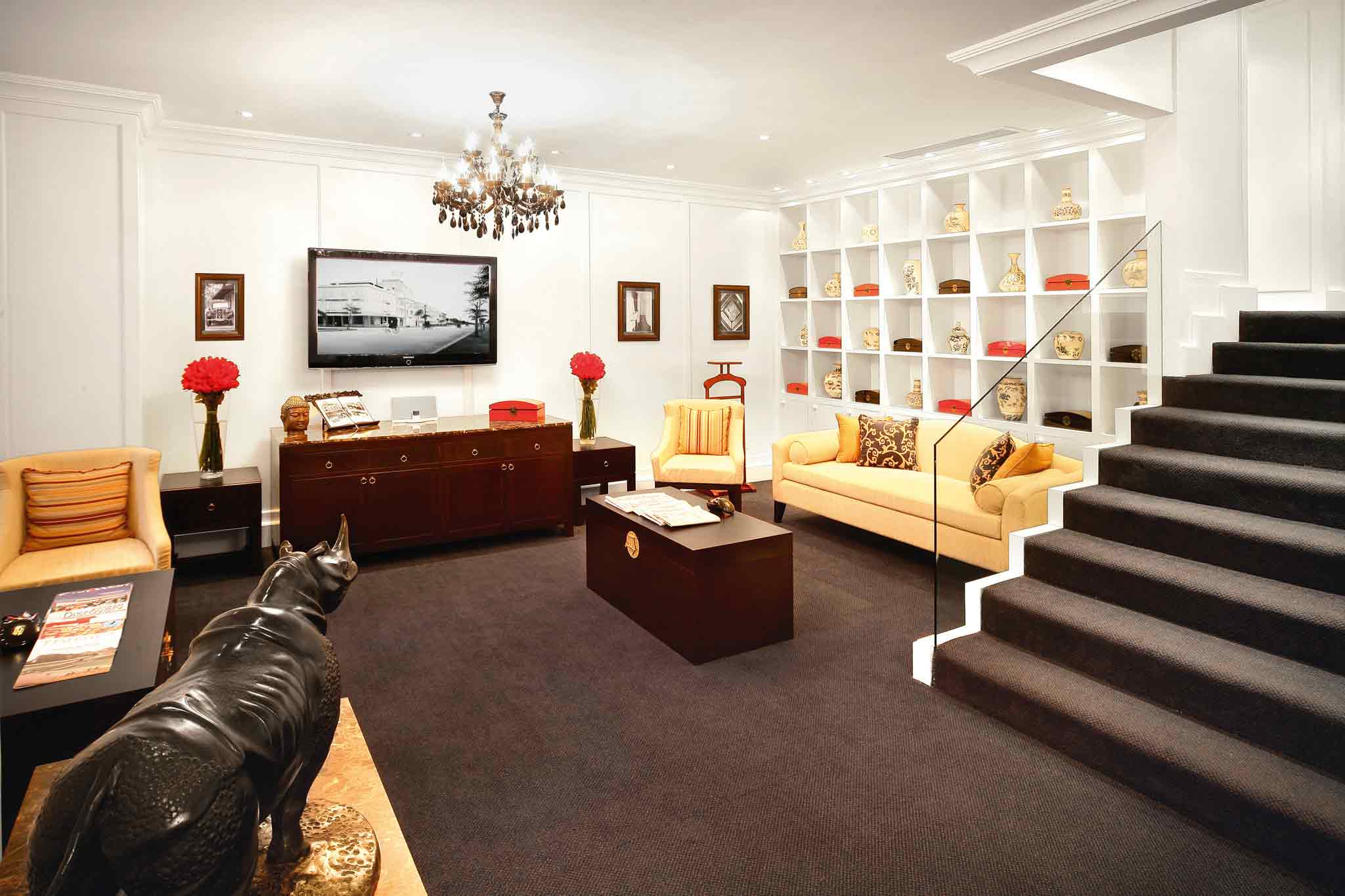 a room with a staircase and a statue