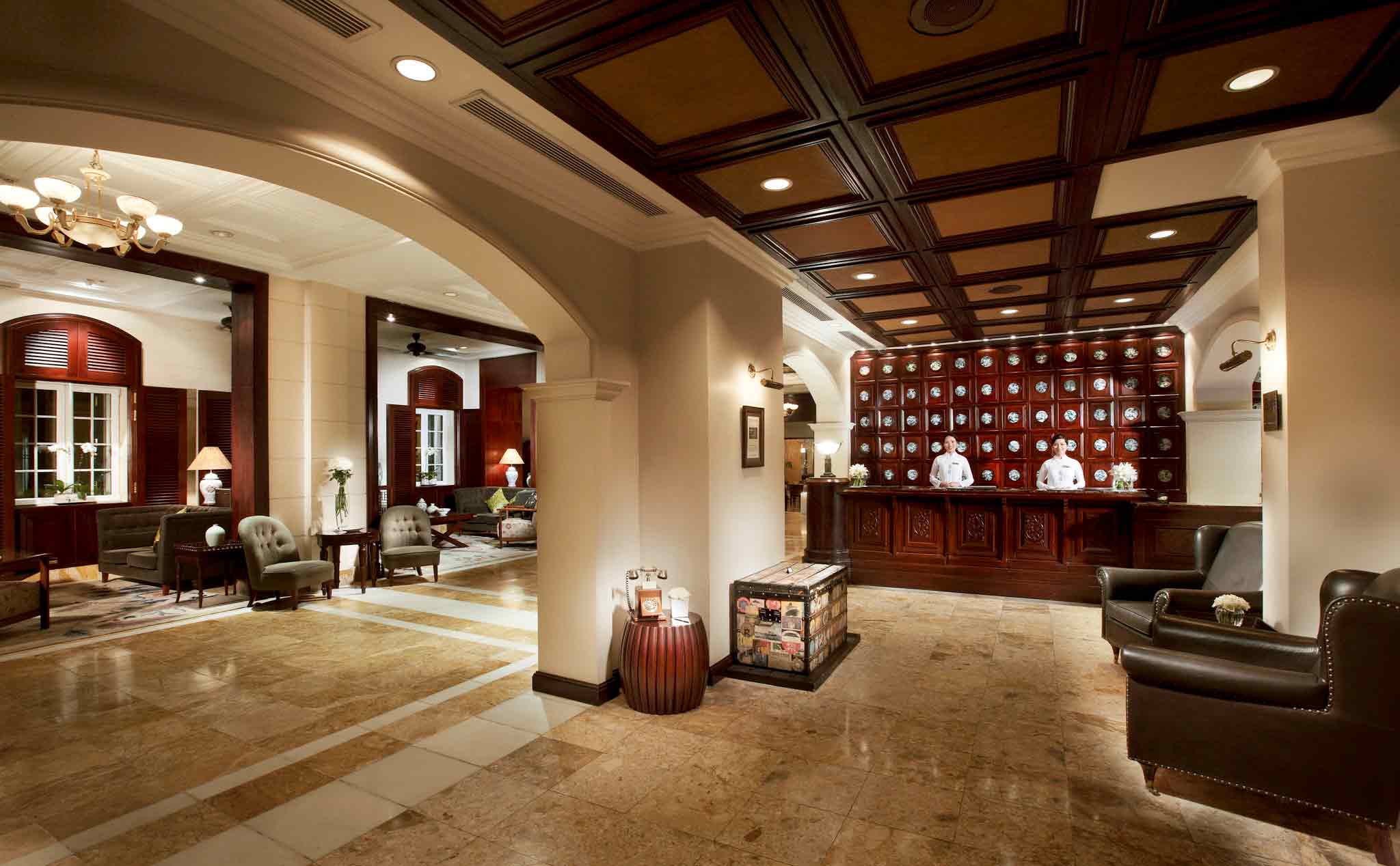 a hotel lobby with a couple of men standing at the counter