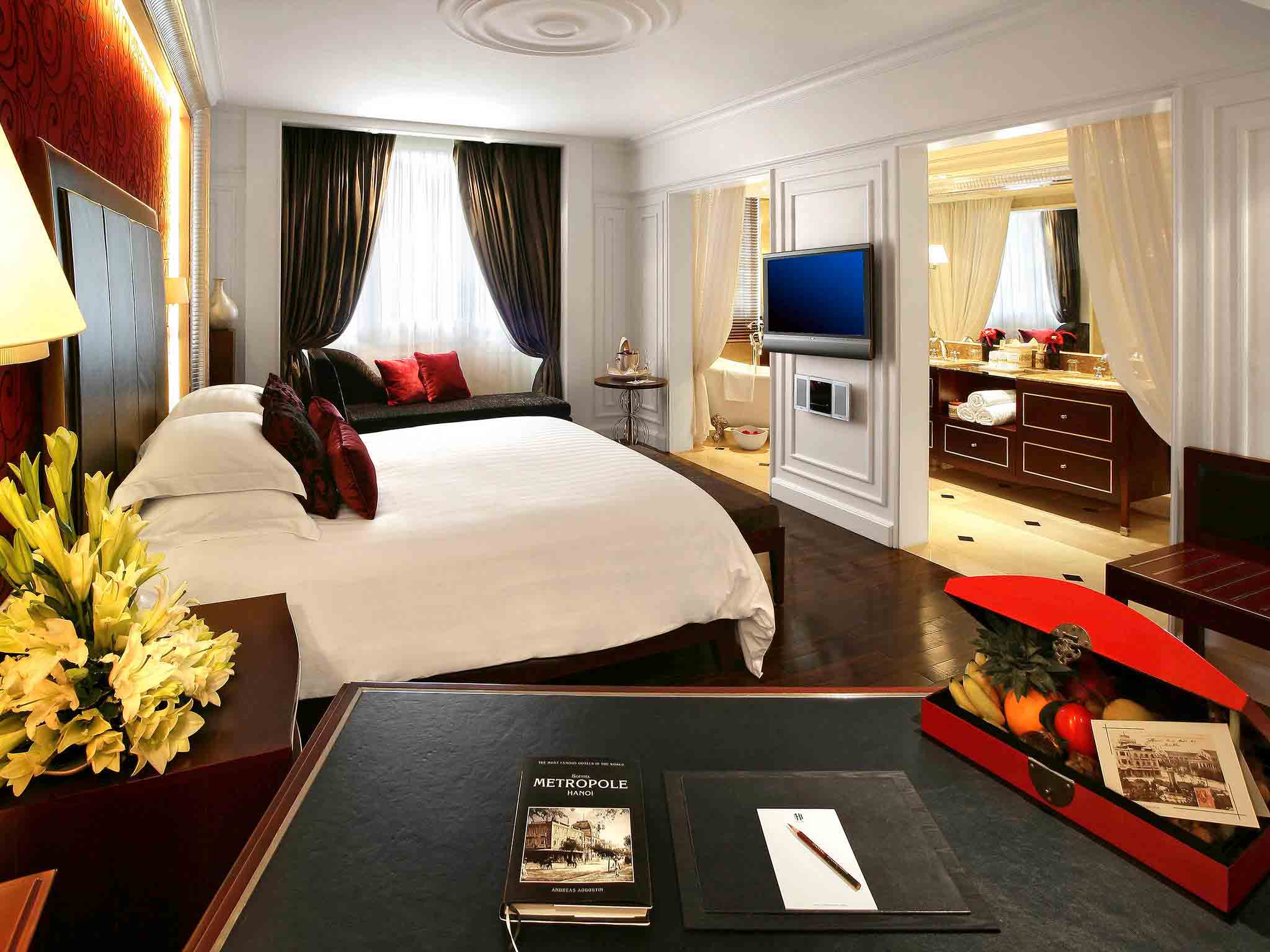 a room with a bed and a television