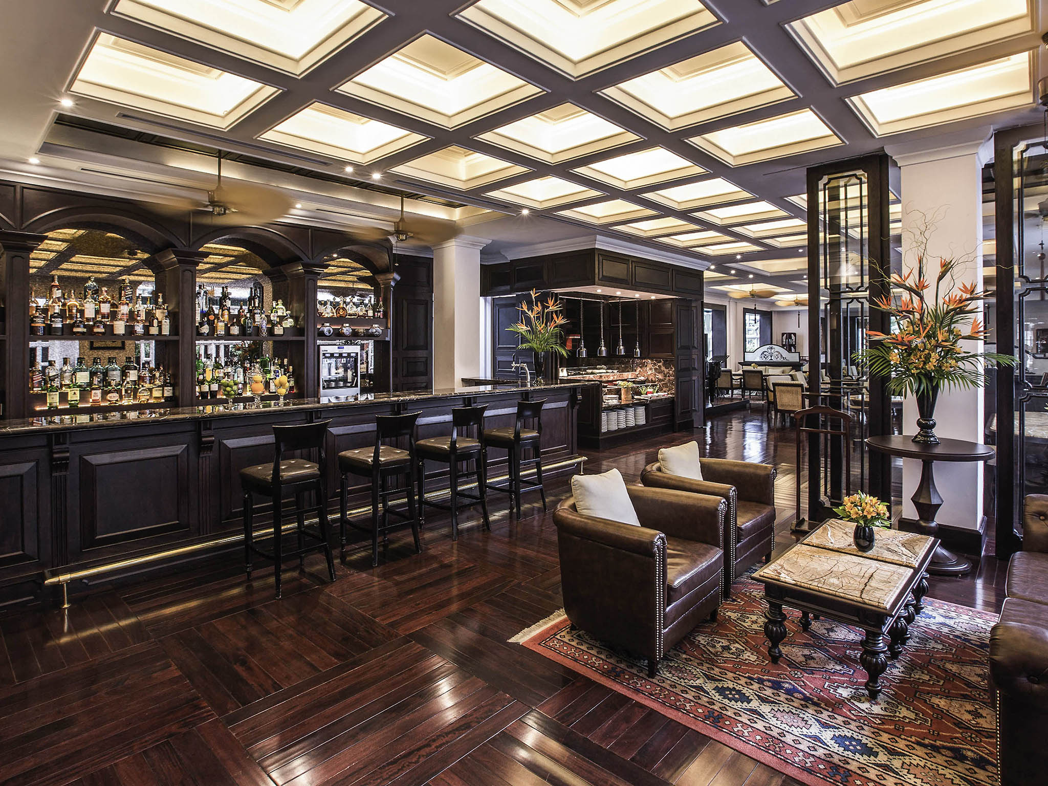 a room with a bar and chairs