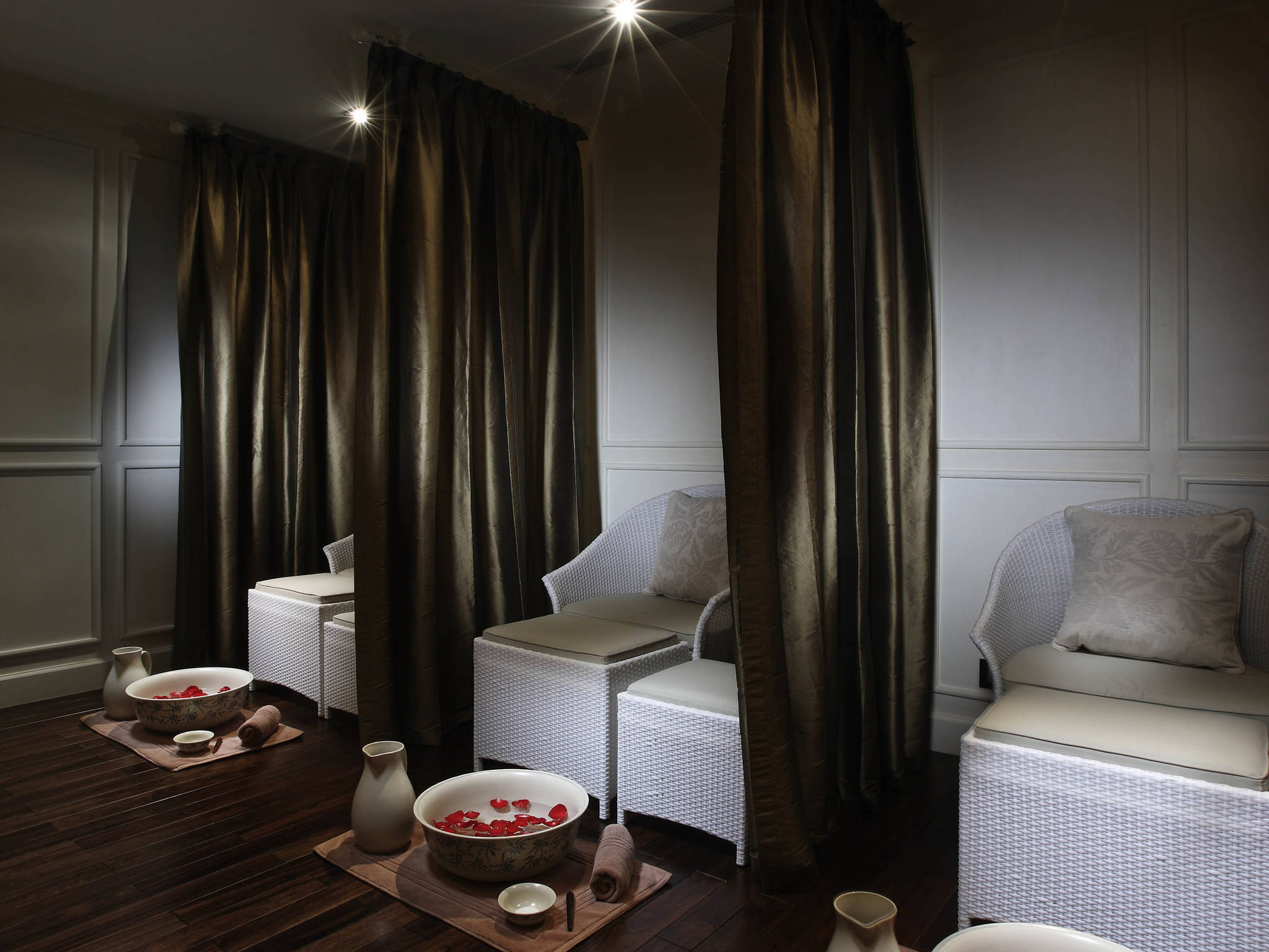 a room with white chairs and brown curtains