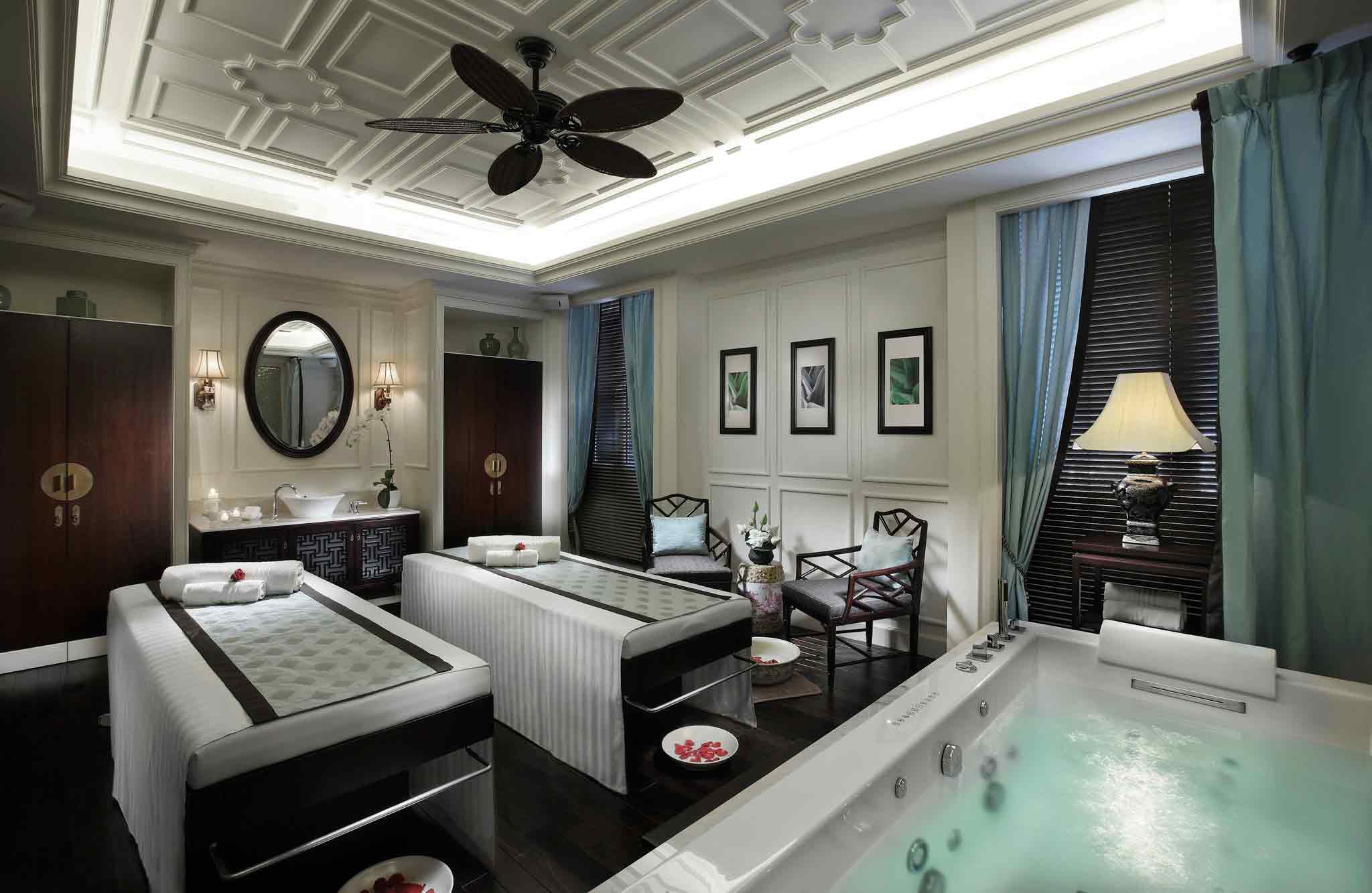 a room with beds and a hot tub
