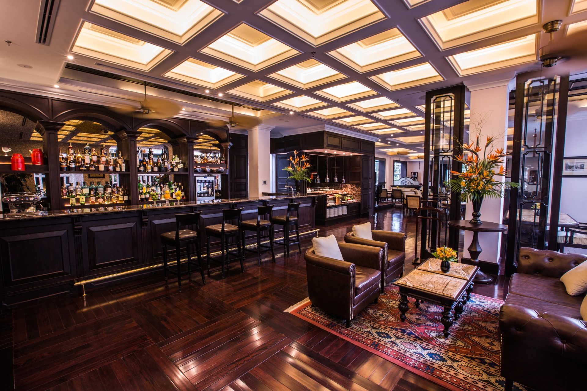 a room with a bar and chairs