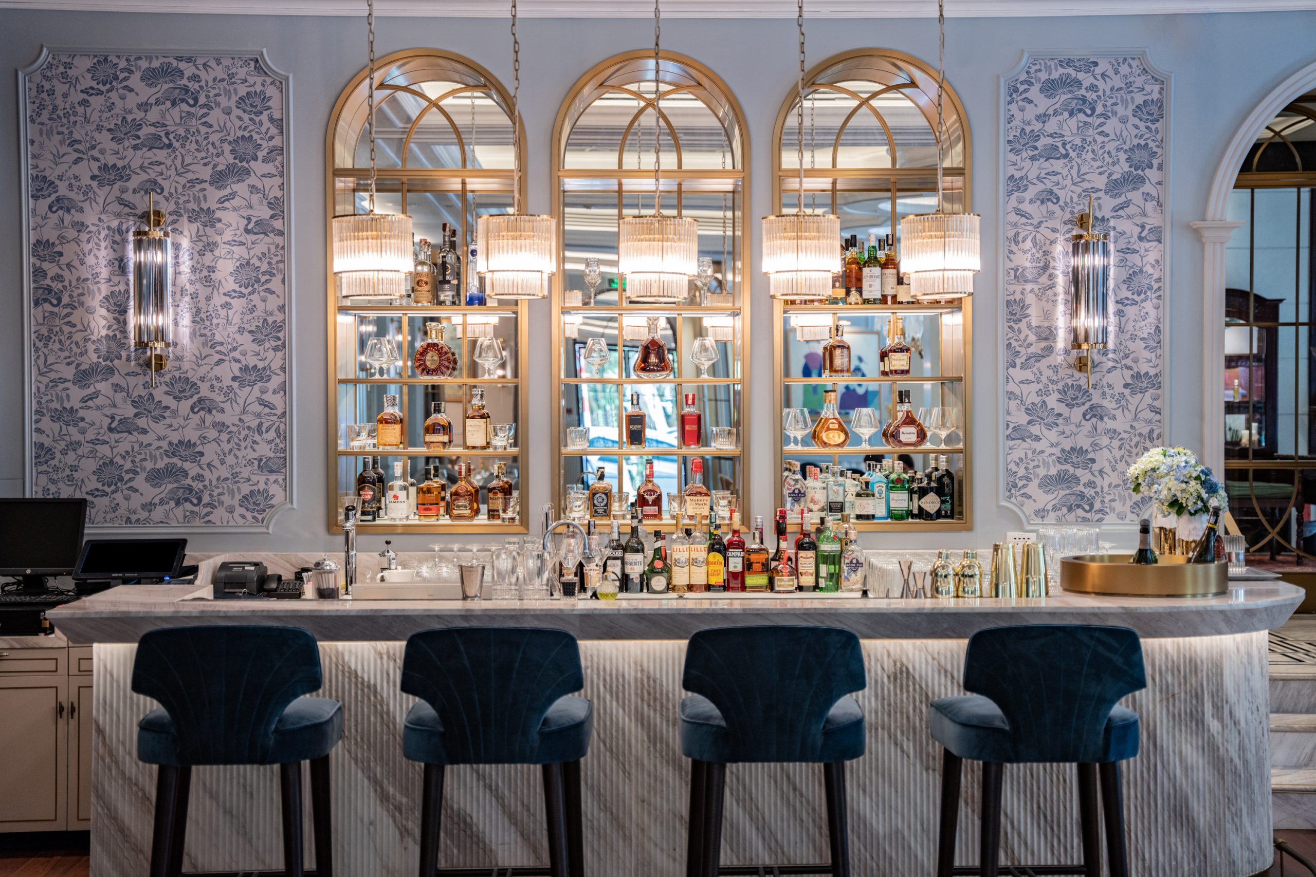a bar with bottles of alcohol and a shelf with lights