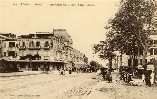 a street with a few buildings and a horse carriage