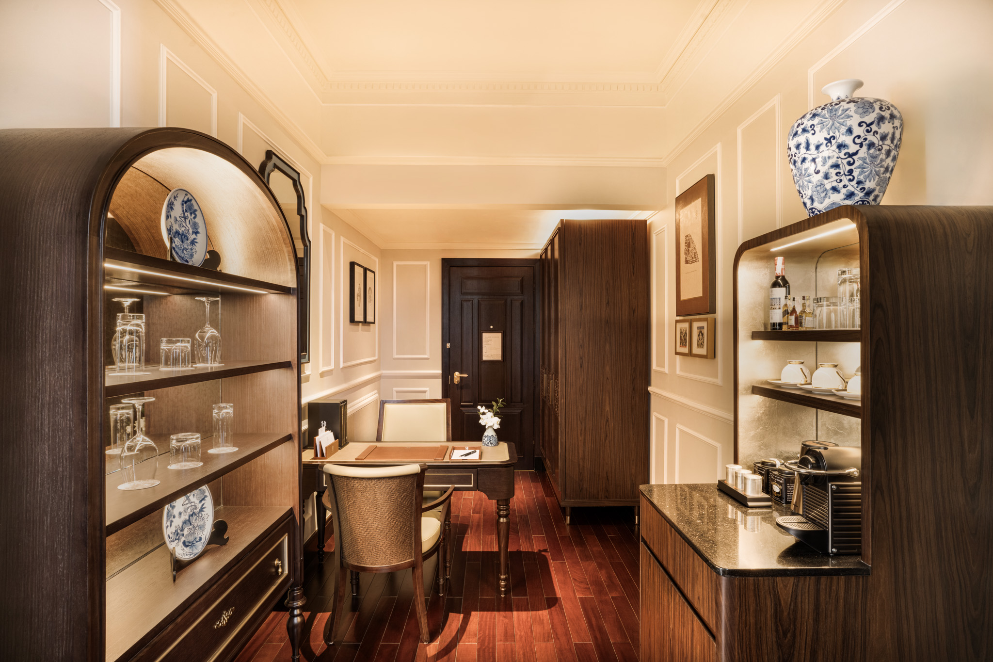 a room with a table and chairs and shelves