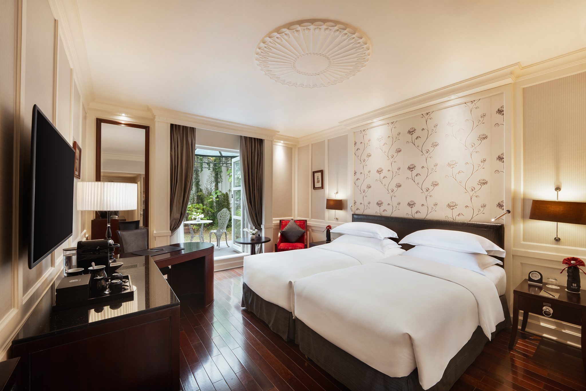 a room with two beds and a desk