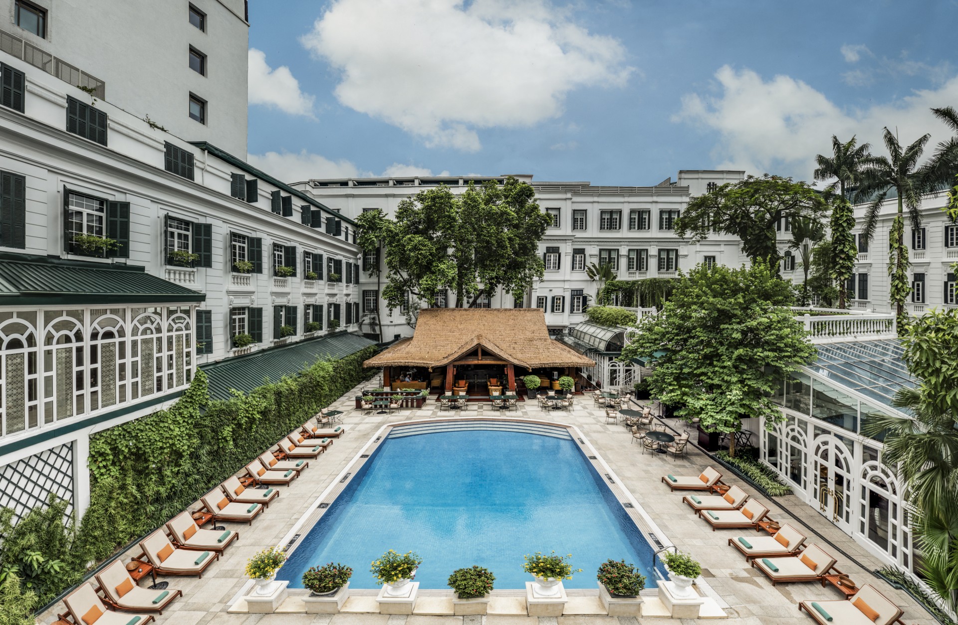 a swimming pool with lounge chairs and a building