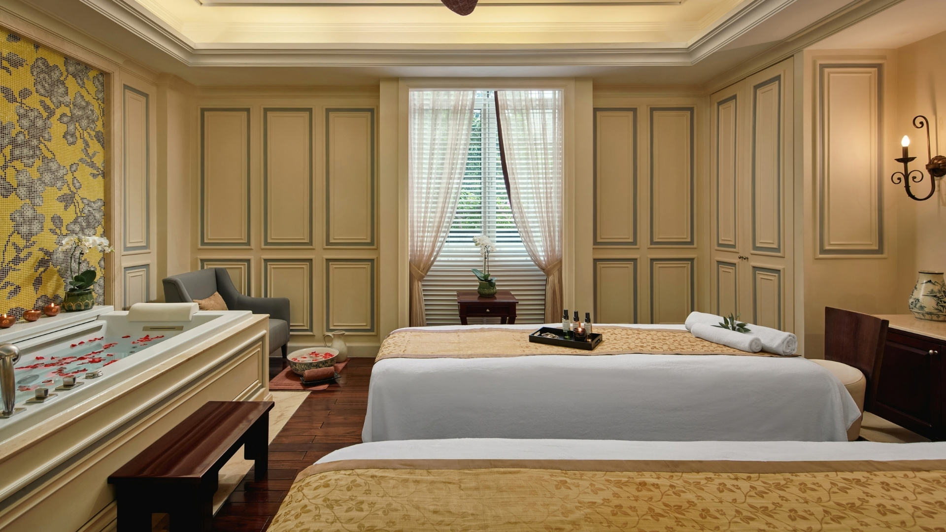 a room with two beds and a table with candles