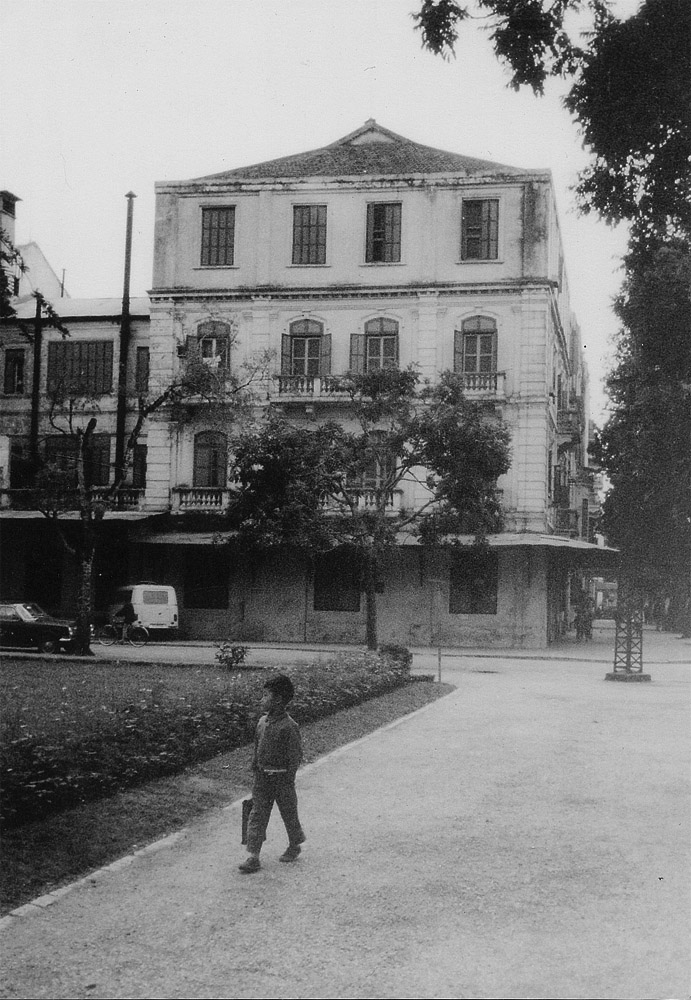 a boy walking on a sidewalk