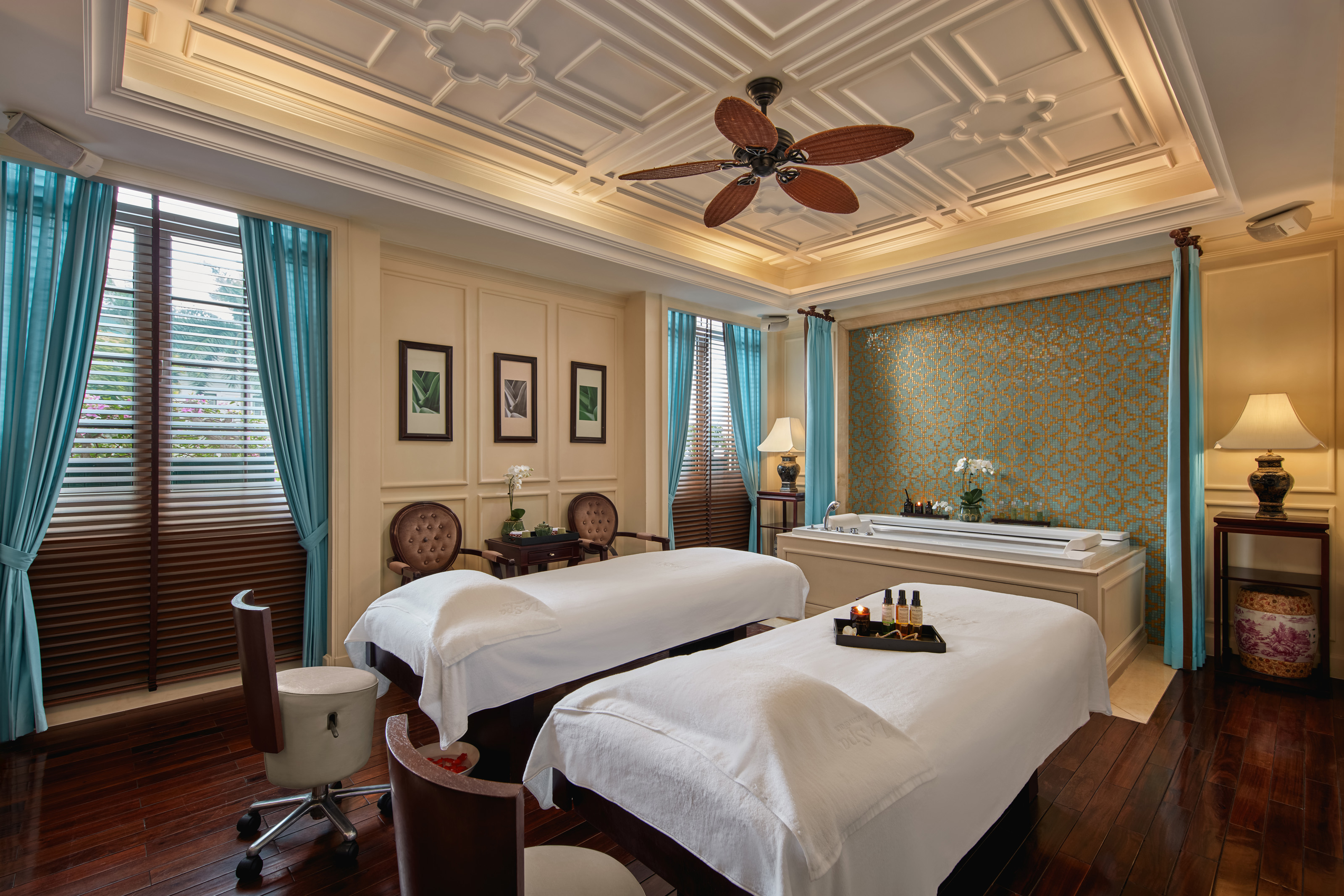 a room with two beds and a fan