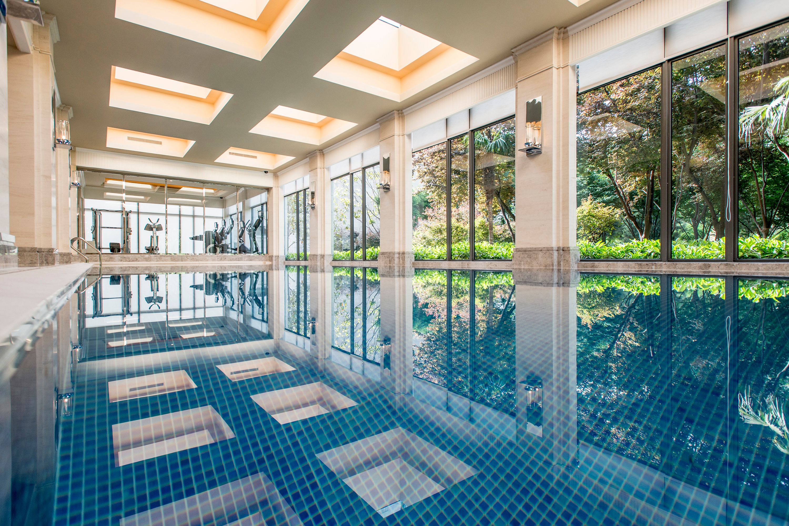 a indoor pool with a large glass wall and a large window