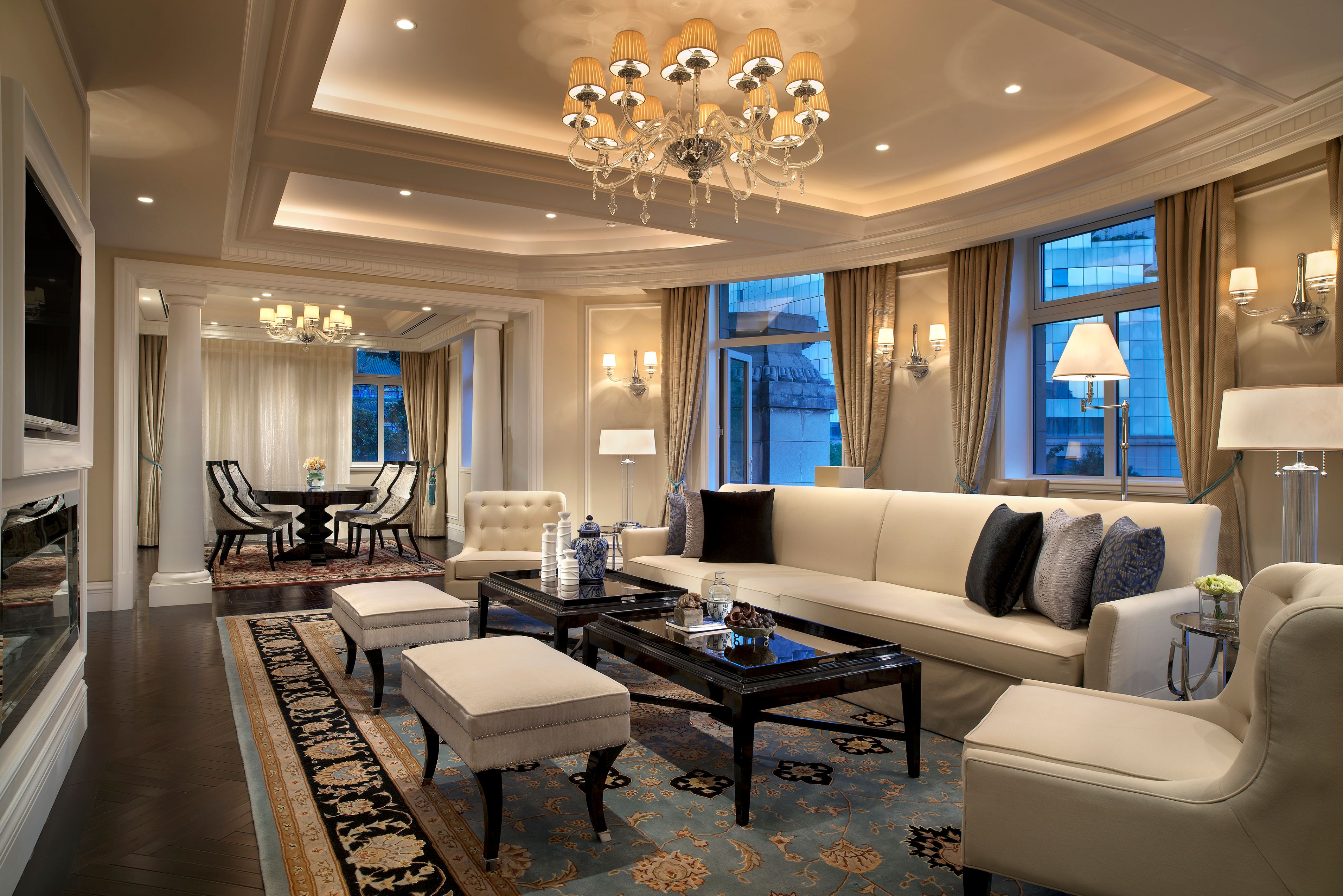a living room with a chandelier and couches