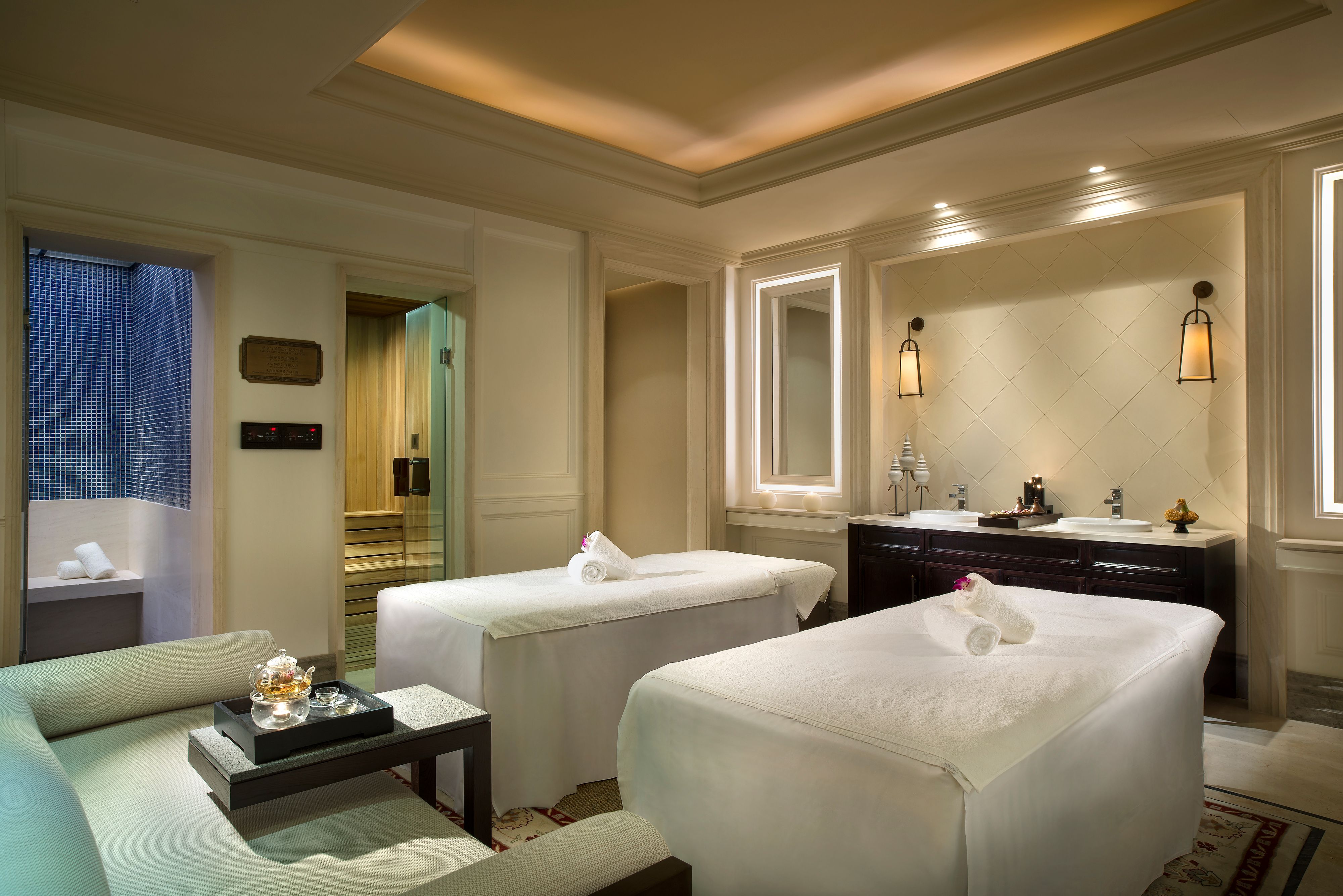 a room with beds and a mirror