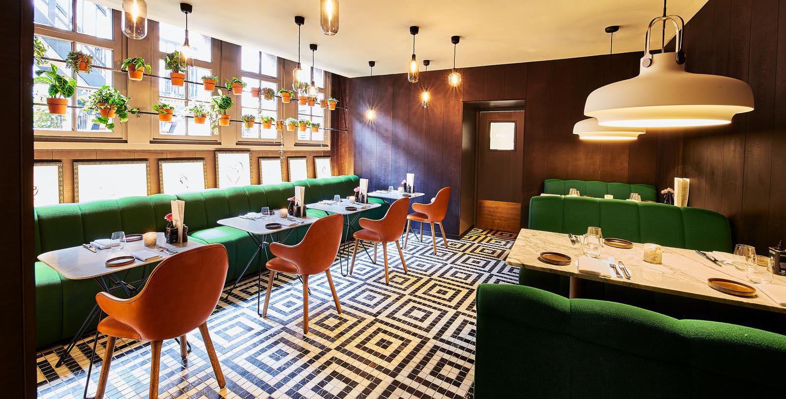 a room with green couches and tables