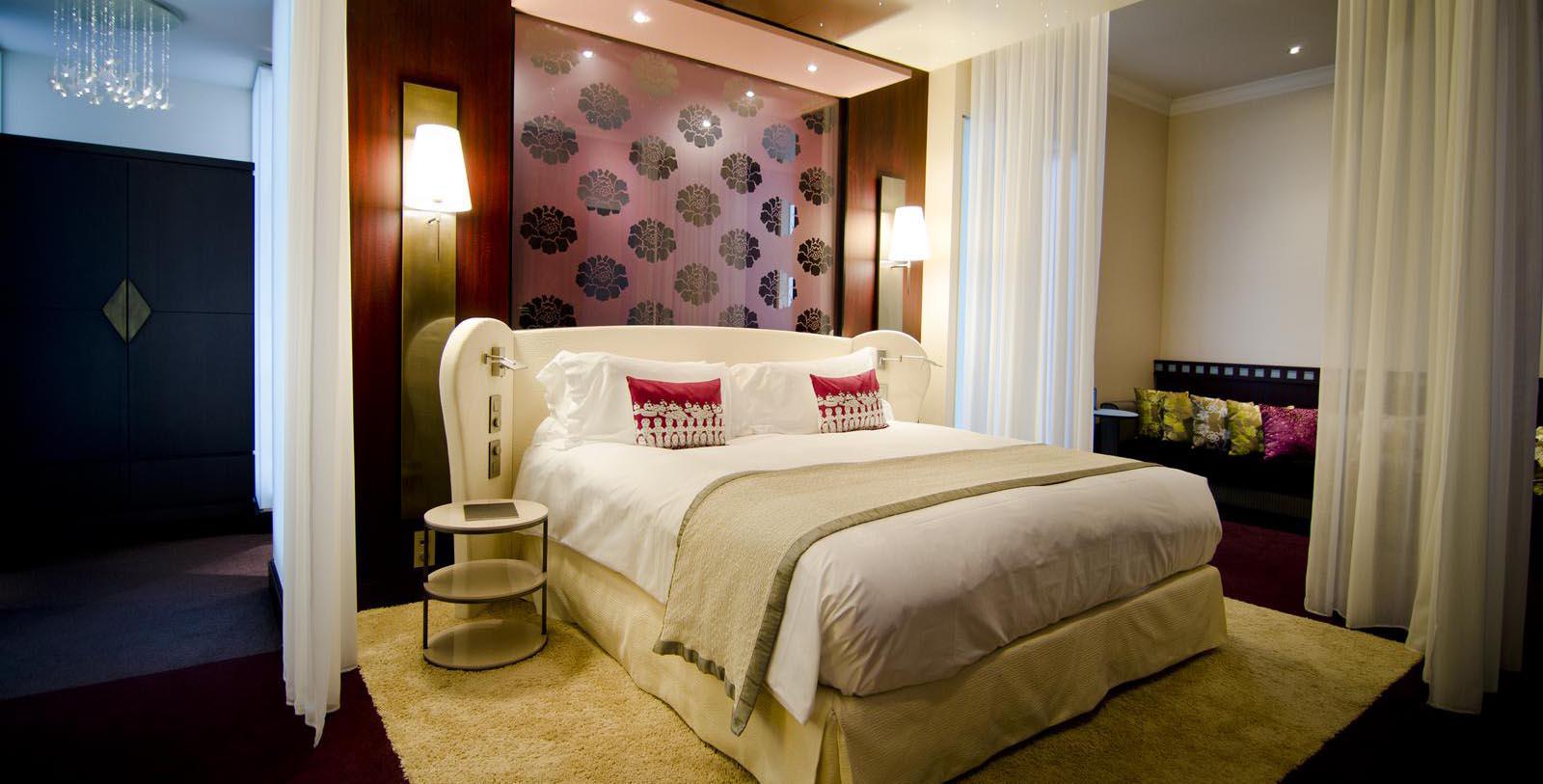 a bed with a glass wall behind it