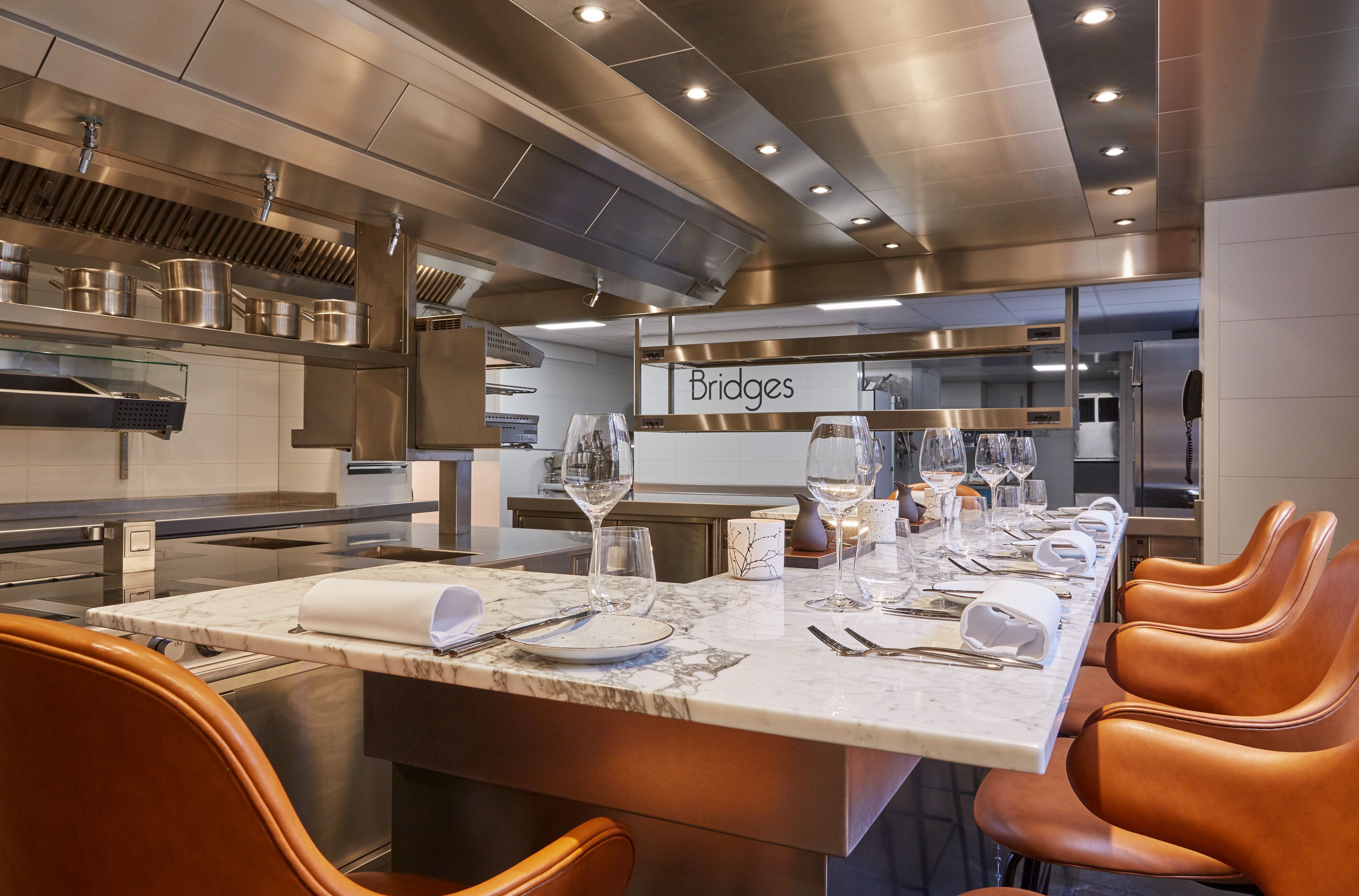 a kitchen with a long table and chairs
