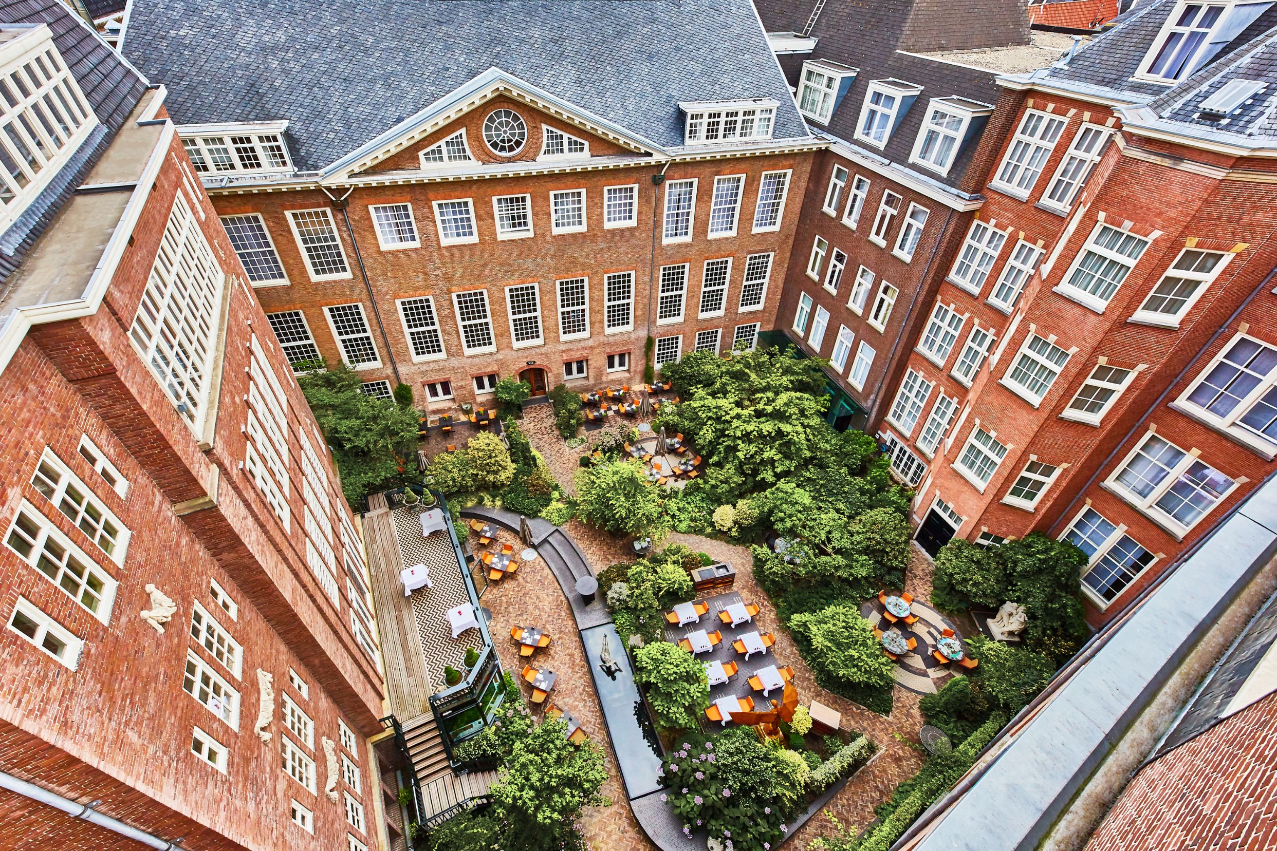 a courtyard with tables and chairs in a courtyard